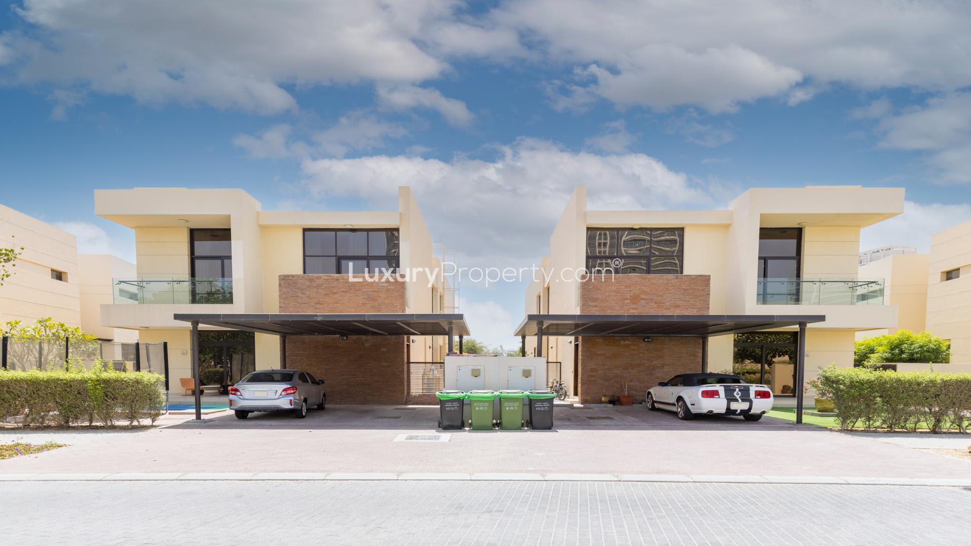 Villa exterior with carport in Damac Hills, Brookfield community, featuring modern architecture