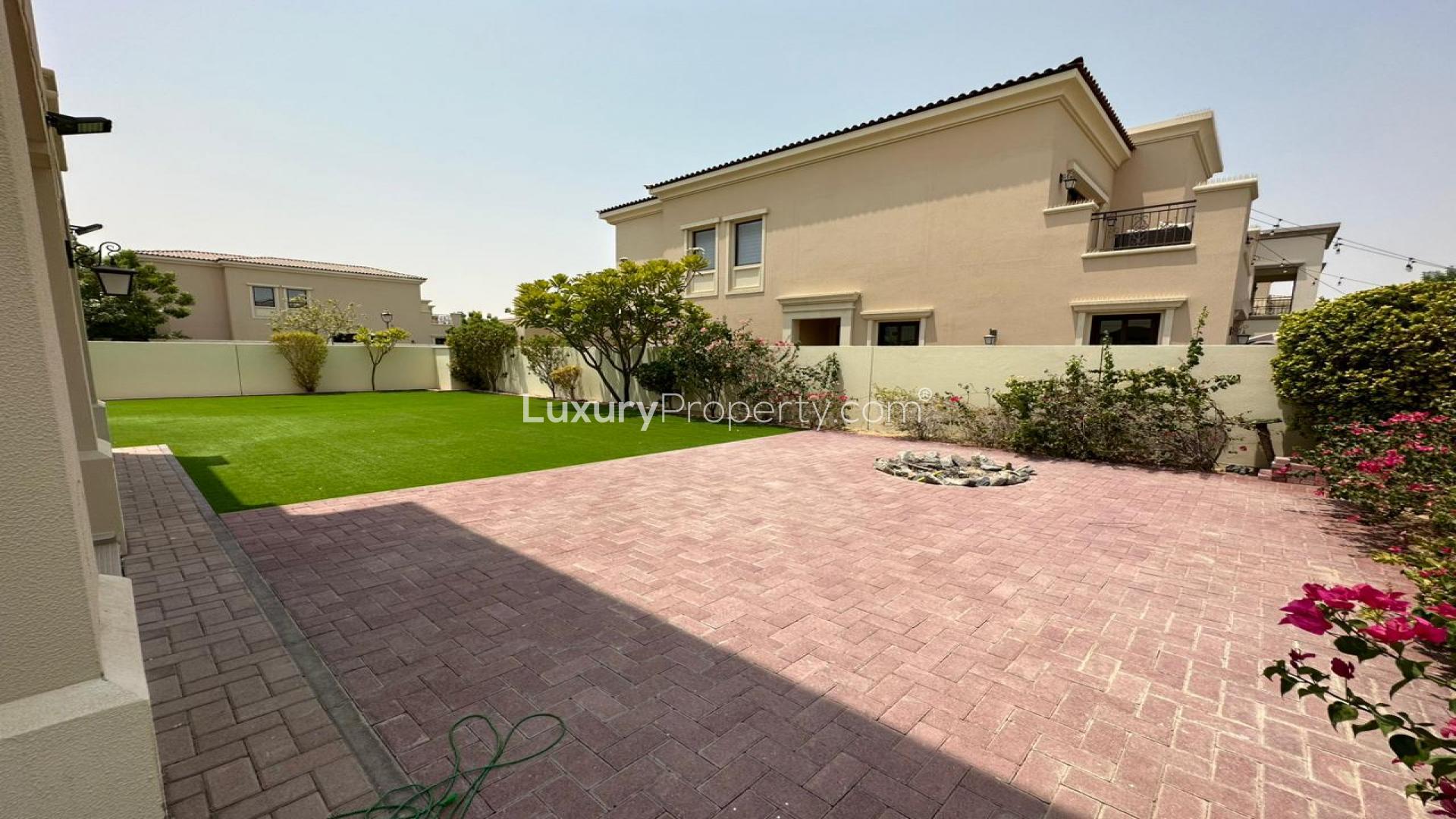 Spacious living room in 5-bedroom Lila Villa, Arabian Ranches 2, with garden view