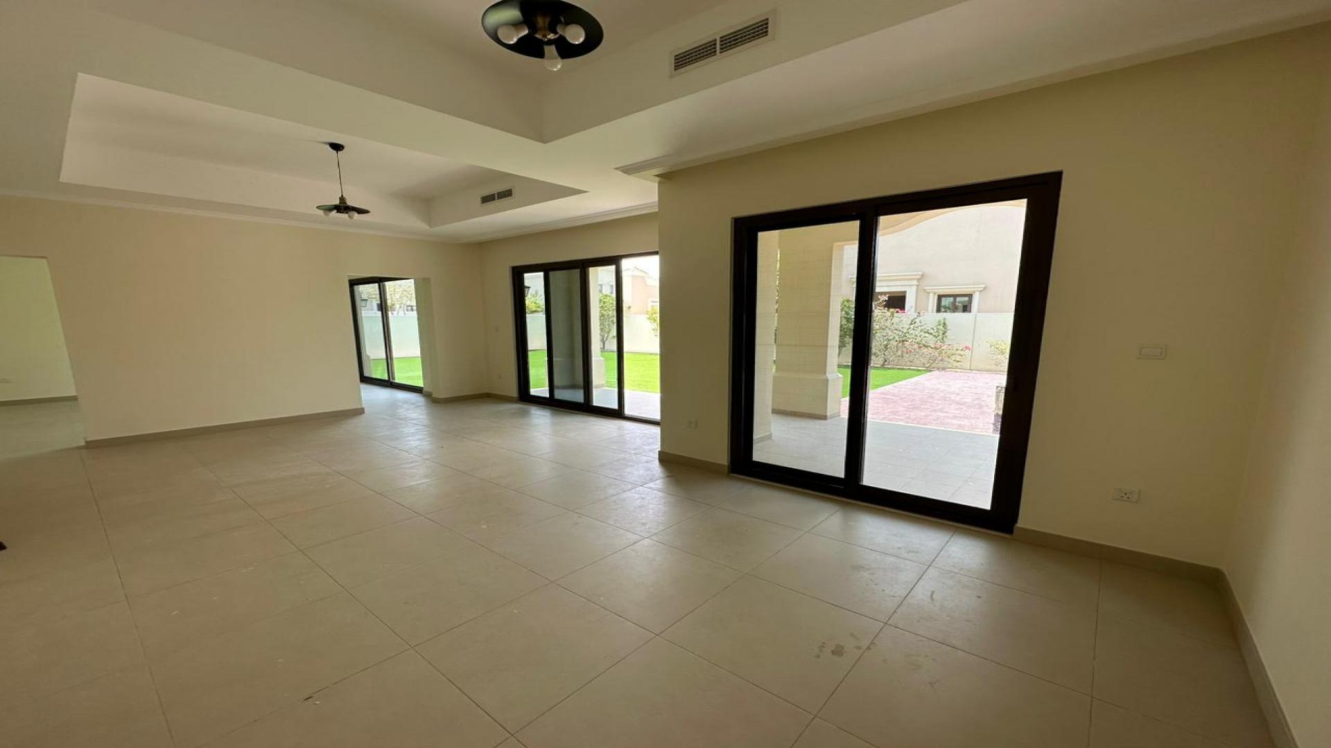 "Spacious backyard of Lila Villa in Arabian Ranches 2 with lawn and patio area.",Spacious living area in unoccupied 5-bedroom Lila Villa, Arabian Ranches 2 for rent