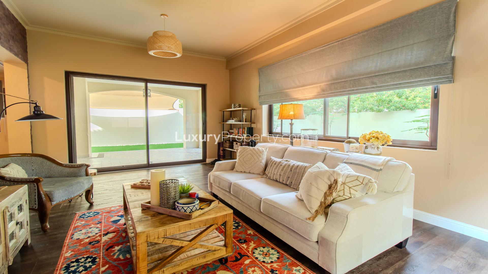 "Elegant garden view of luxury villa in Samara, Arabian Ranches 2, for rent.",Living room in luxury villa, Samara, Arabian Ranches 2, with cozy decor and garden view