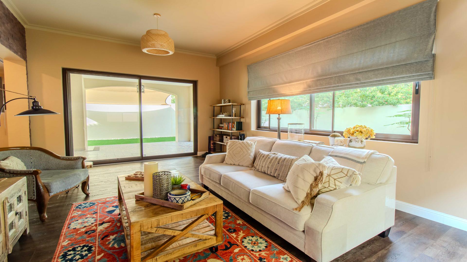 "Elegant garden view of luxury villa in Samara, Arabian Ranches 2, for rent.",Living room in luxury villa, Samara, Arabian Ranches 2, with cozy decor and garden view