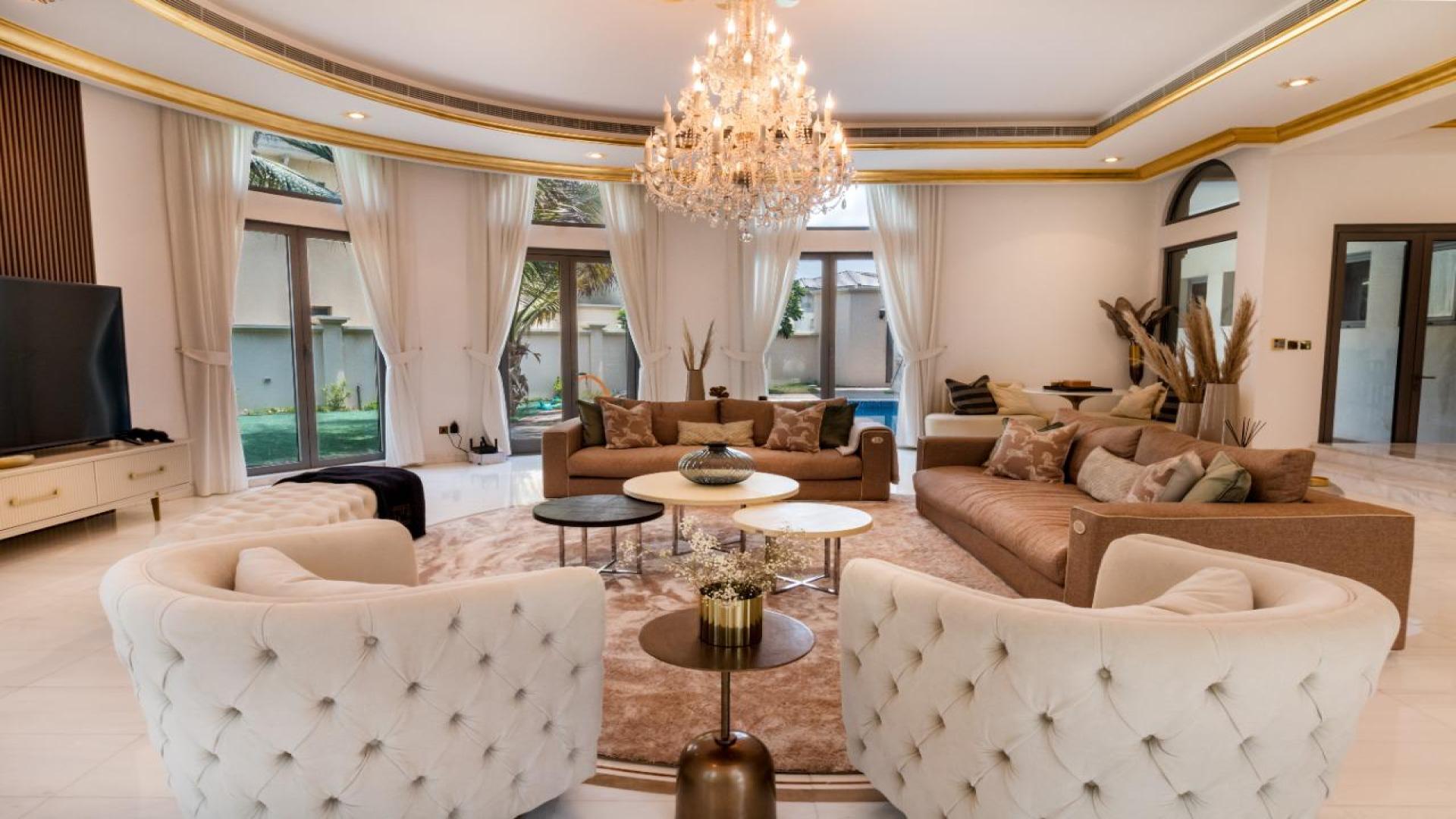 Luxurious living room in Palm Jumeirah villa with elegant furnishings and chandelier