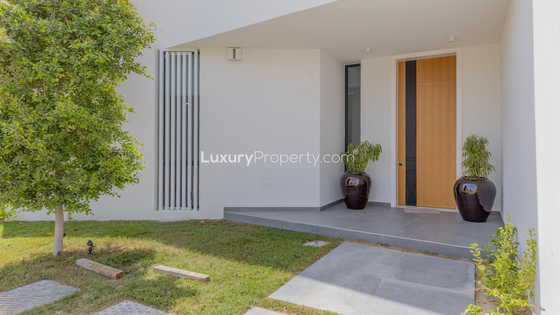 Contemporary villa living room with yellow seating, large windows in Al Barari, Chorisia 1