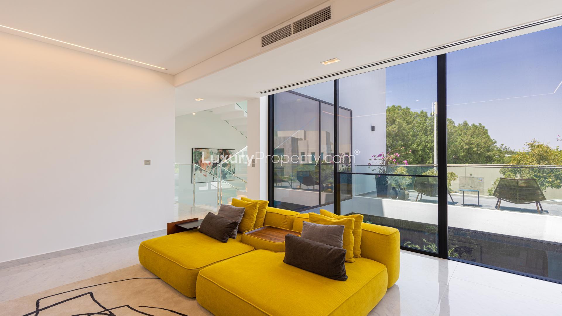 Outdoor patio of Chorisia 1 Villa, Al Barari, with modern seating and garden view