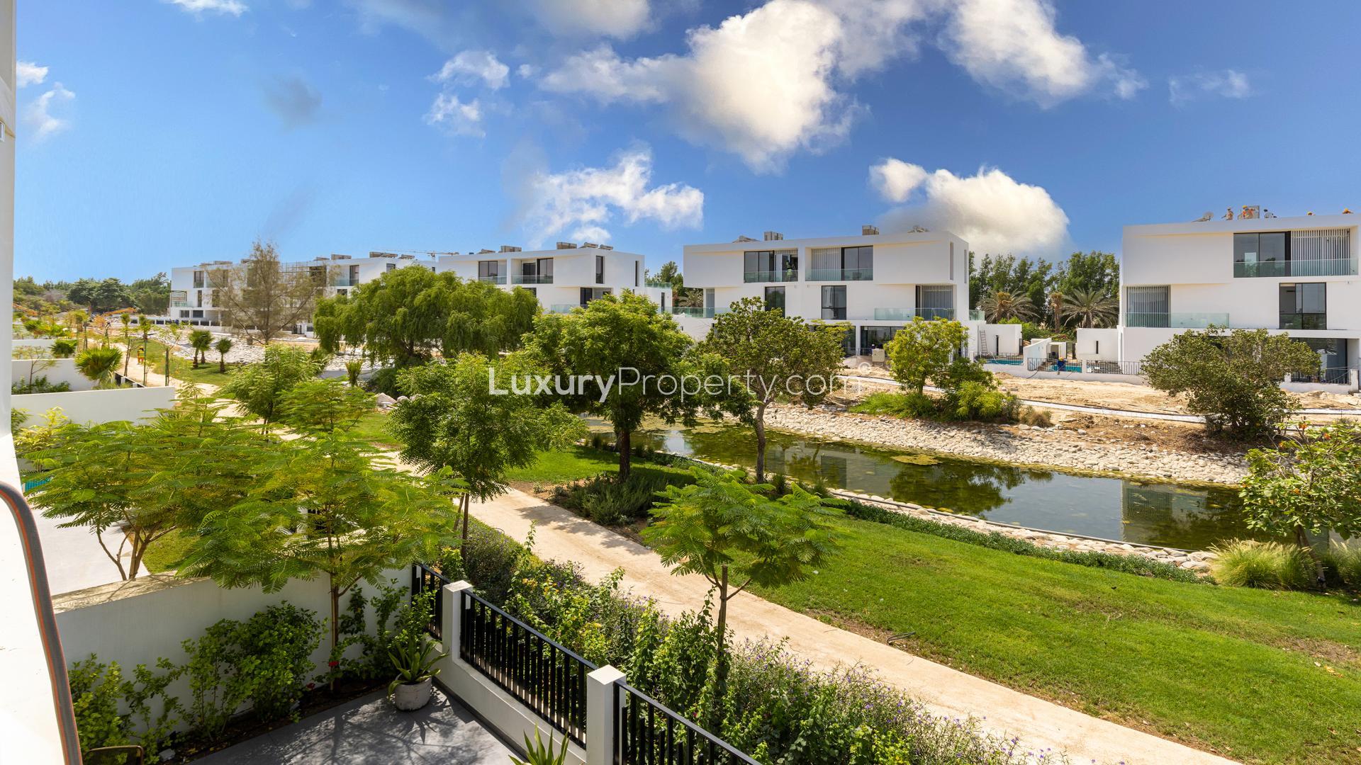 Bright modern living room in luxury Al Barari villa with yellow sofa and sleek decor
