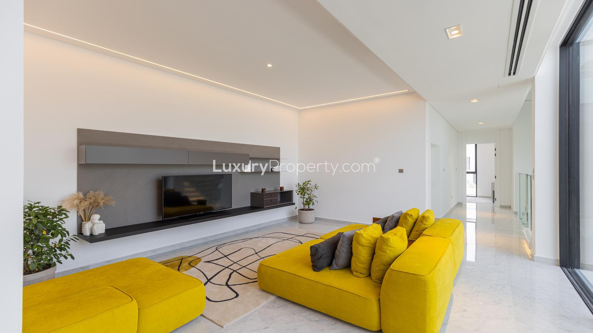 Modern living room in Chorisia 1 Villa, Al Barari with pop art and yellow sofa