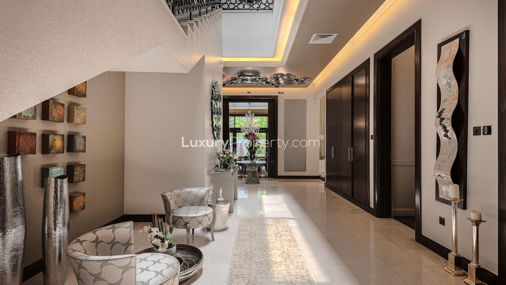 Luxury Al Barari villa poolside view with loungers, lush garden, and elegant architecture