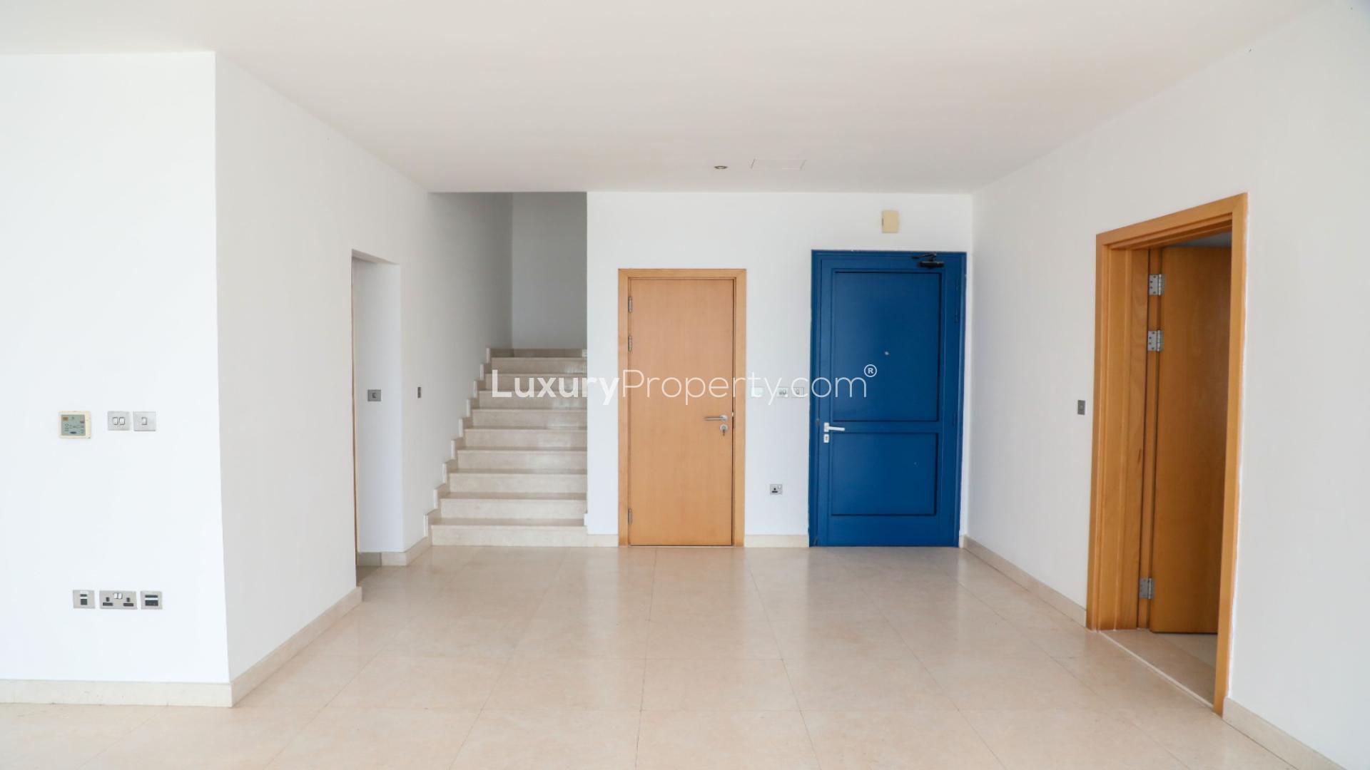 "Spacious living room with ocean view in Palma Residences beach villa, Palm Jumeirah.",Interior hallway with staircase in luxury 5-bed villa, Palma Residences, Palm Jumeirah