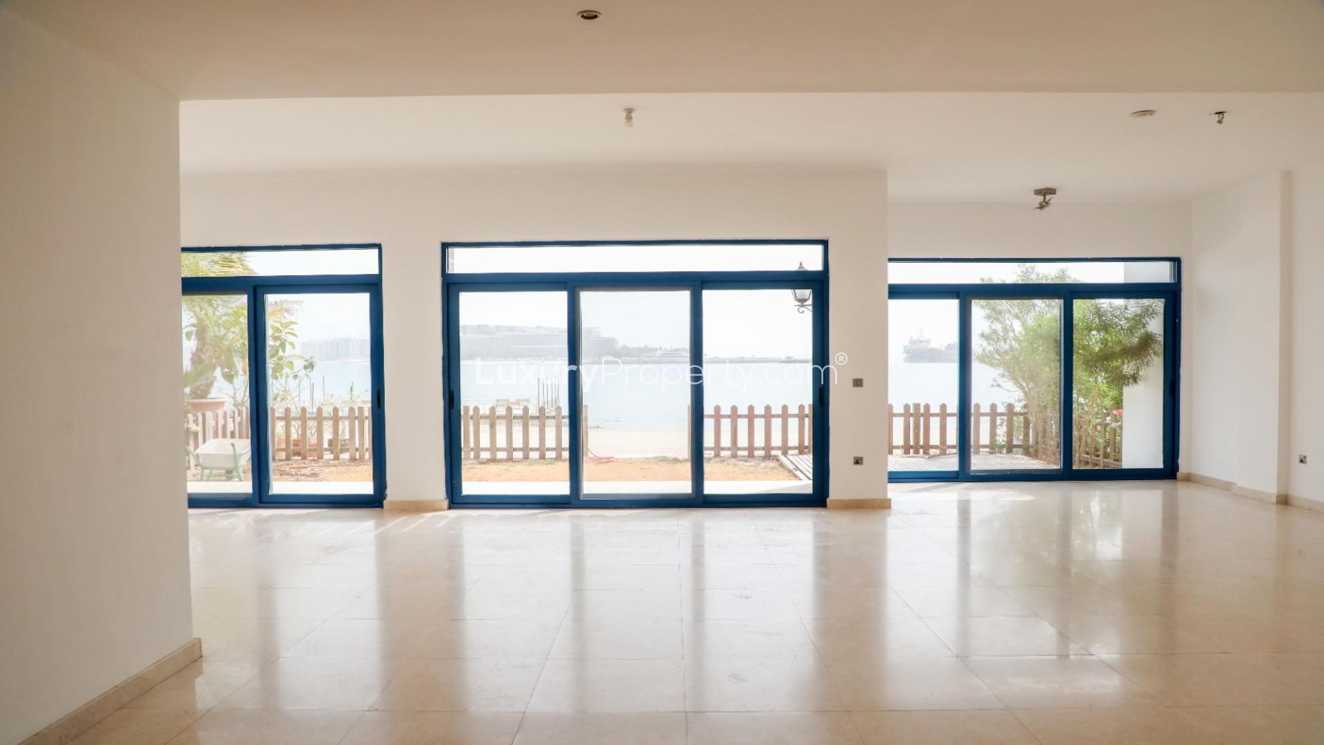 Beachfront villa exterior with large windows in Palma Residences, Palm Jumeirah