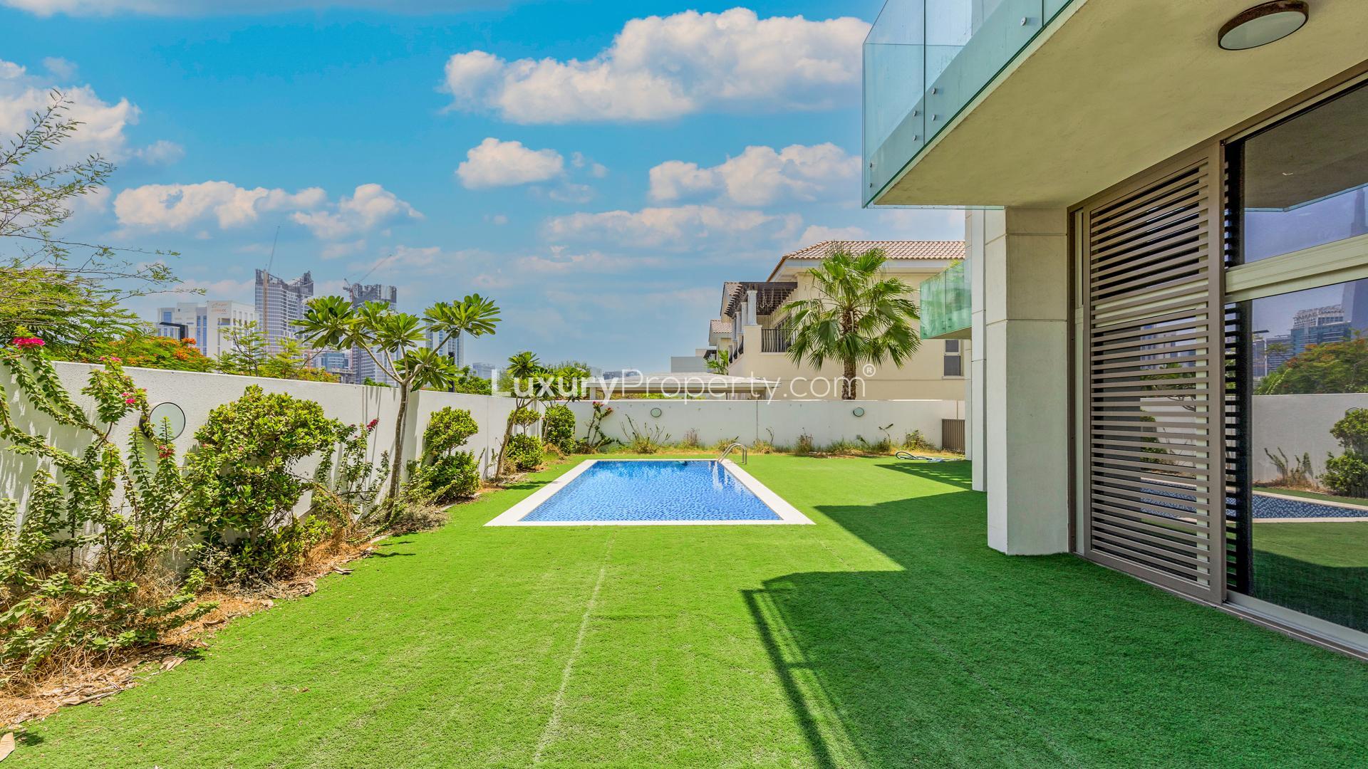 Spacious villa interior with marble floors and garden view in District One, MBR City