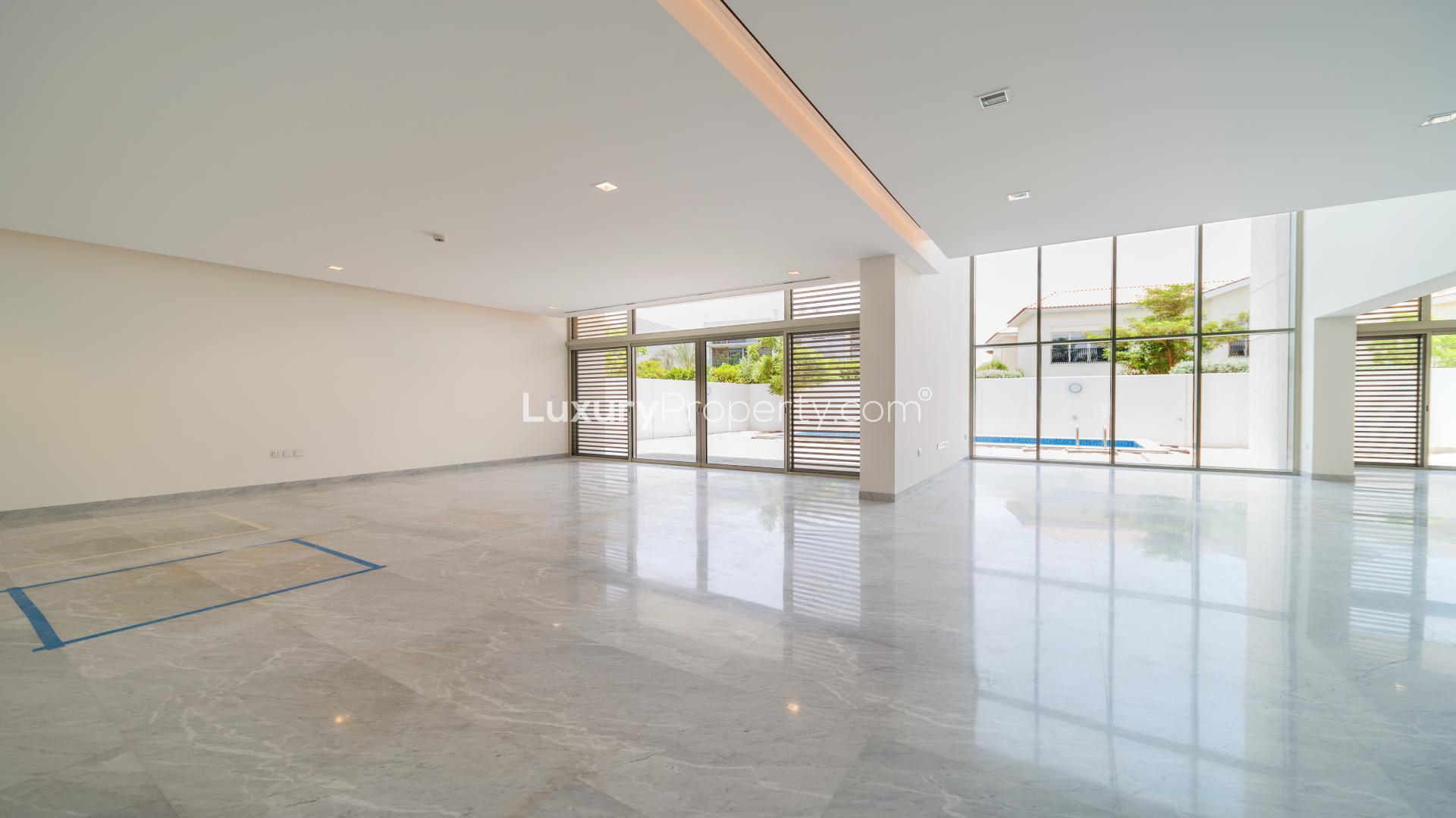 Contemporary villa exterior in District One, Mohammed Bin Rashid City, with lush greenery and modern design