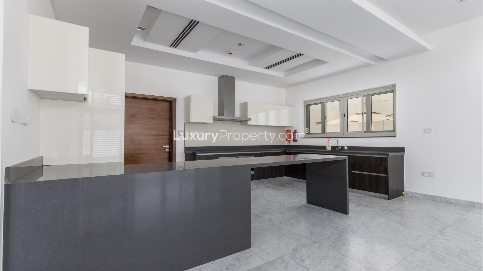 Modern kitchen in 5-bedroom villa, District One, Dubai, with sleek finishes and open layout