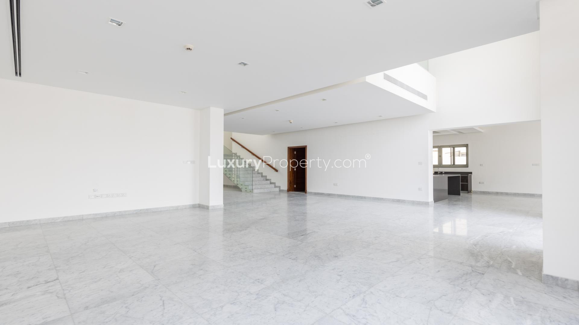 Modern kitchen in 5-bedroom villa, District One, Dubai, featuring sleek countertops and cabinets