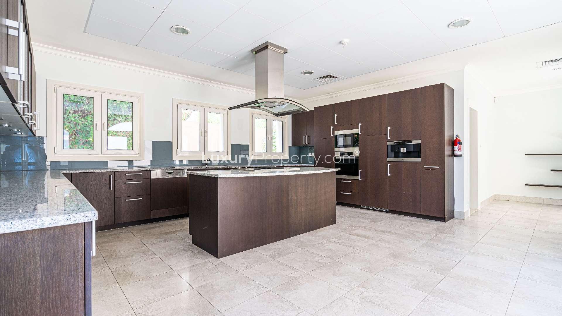 Modern kitchen in Jumeirah Golf Estates villa with sleek cabinetry and spacious layout