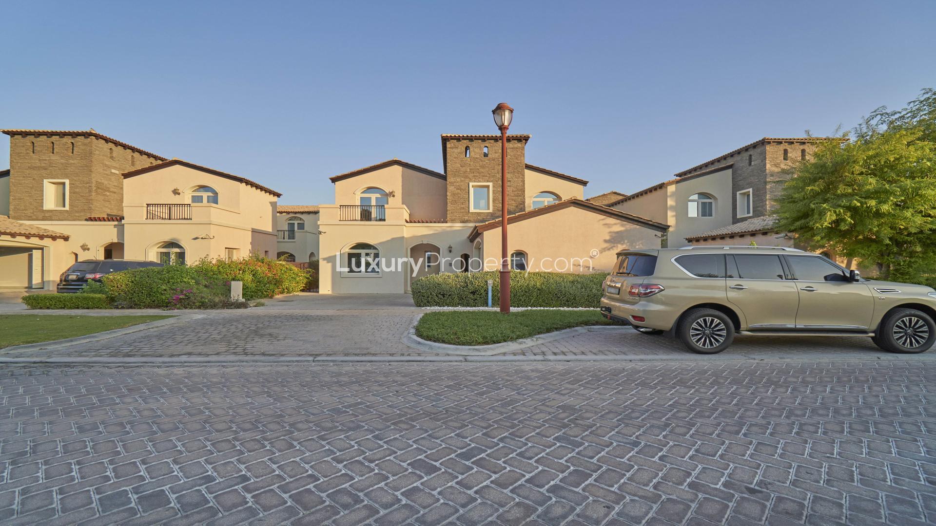 Elegant Sienna Lakes villa exterior in Jumeirah Golf Estates, featuring spacious driveway and garage