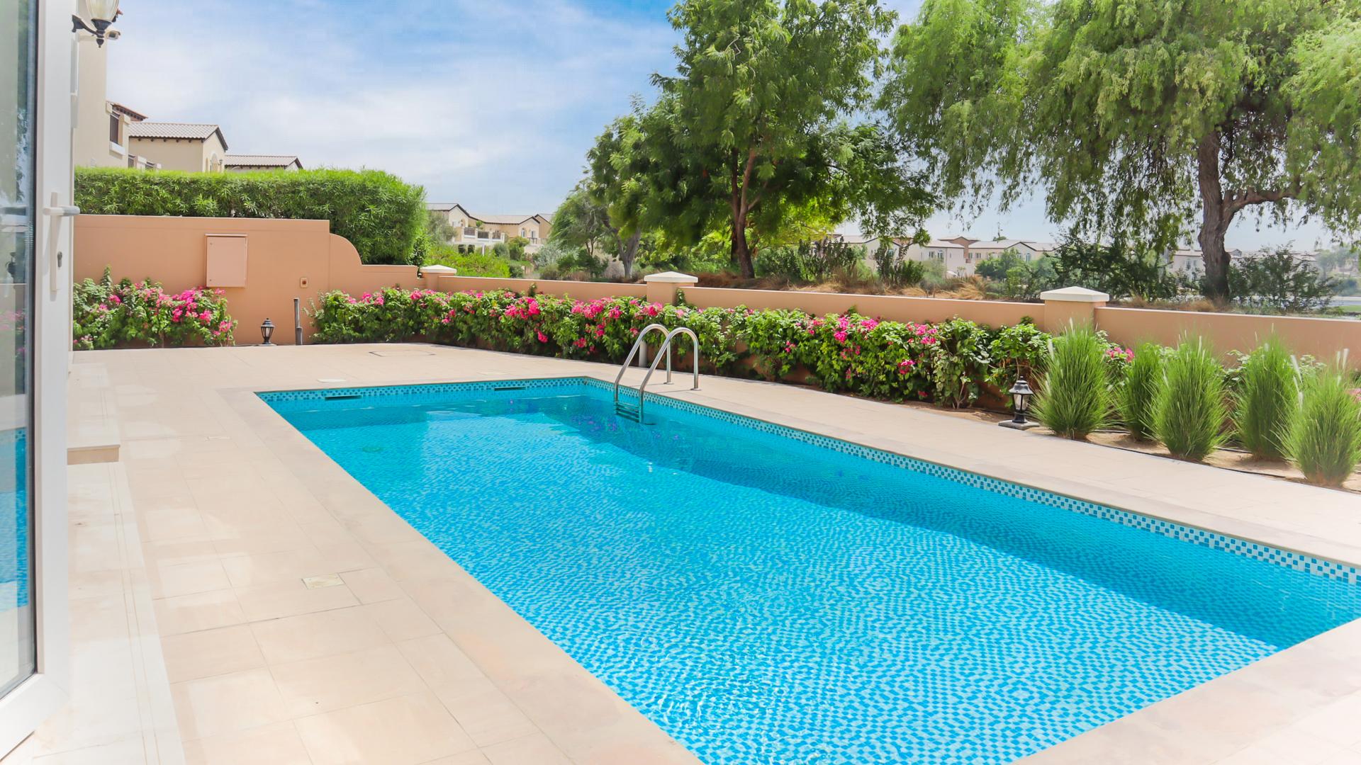 Luxurious villa pool with lush greenery in Jumeirah Golf Estates, Fire community