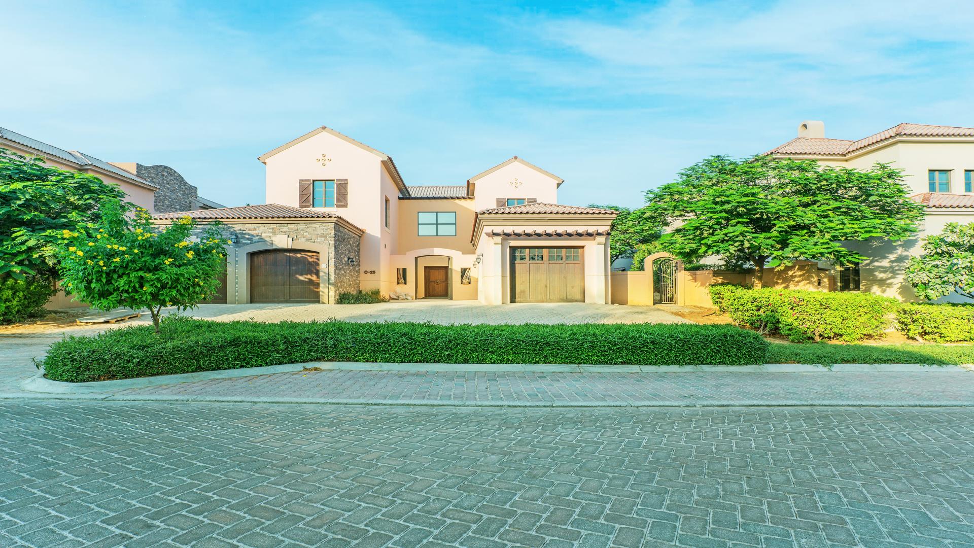 Open-plan kitchen in Jumeirah Golf Estates villa with pool view, for rent