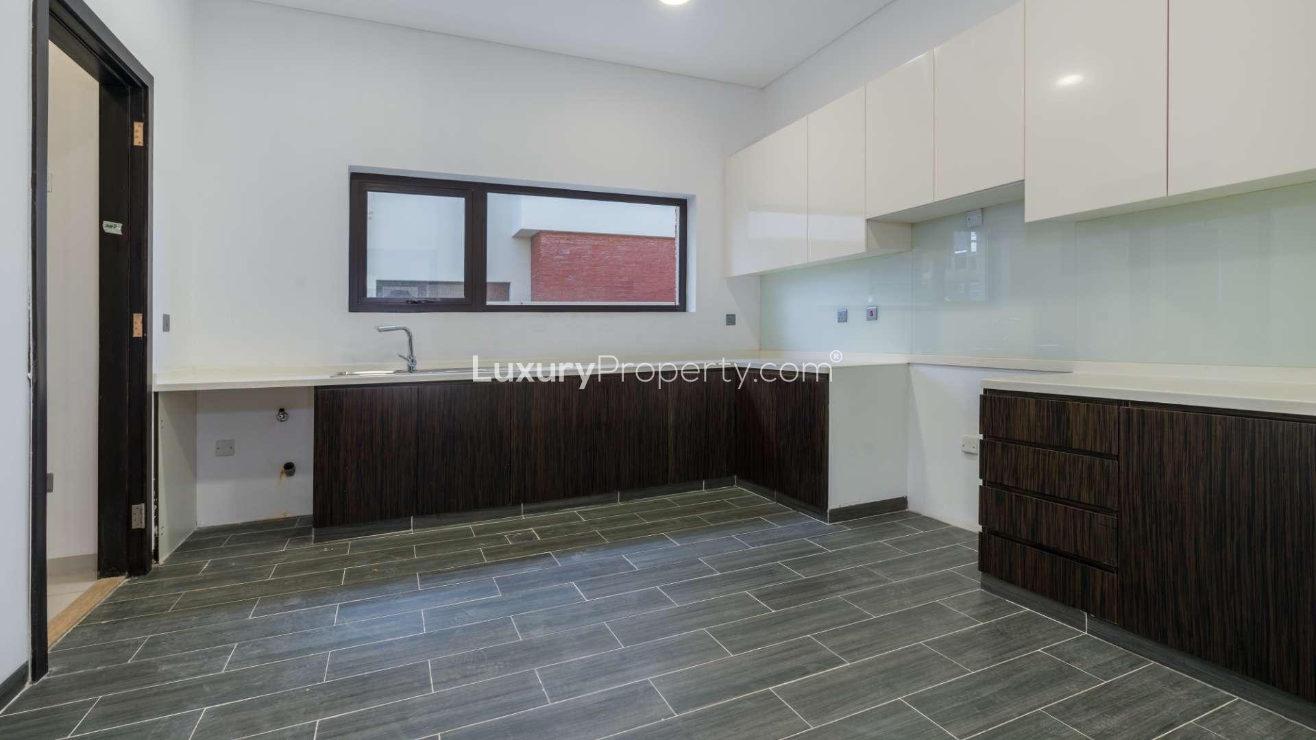 Spacious living area in 5-bedroom villa, The Turf, DAMAC Hills, featuring modern staircase