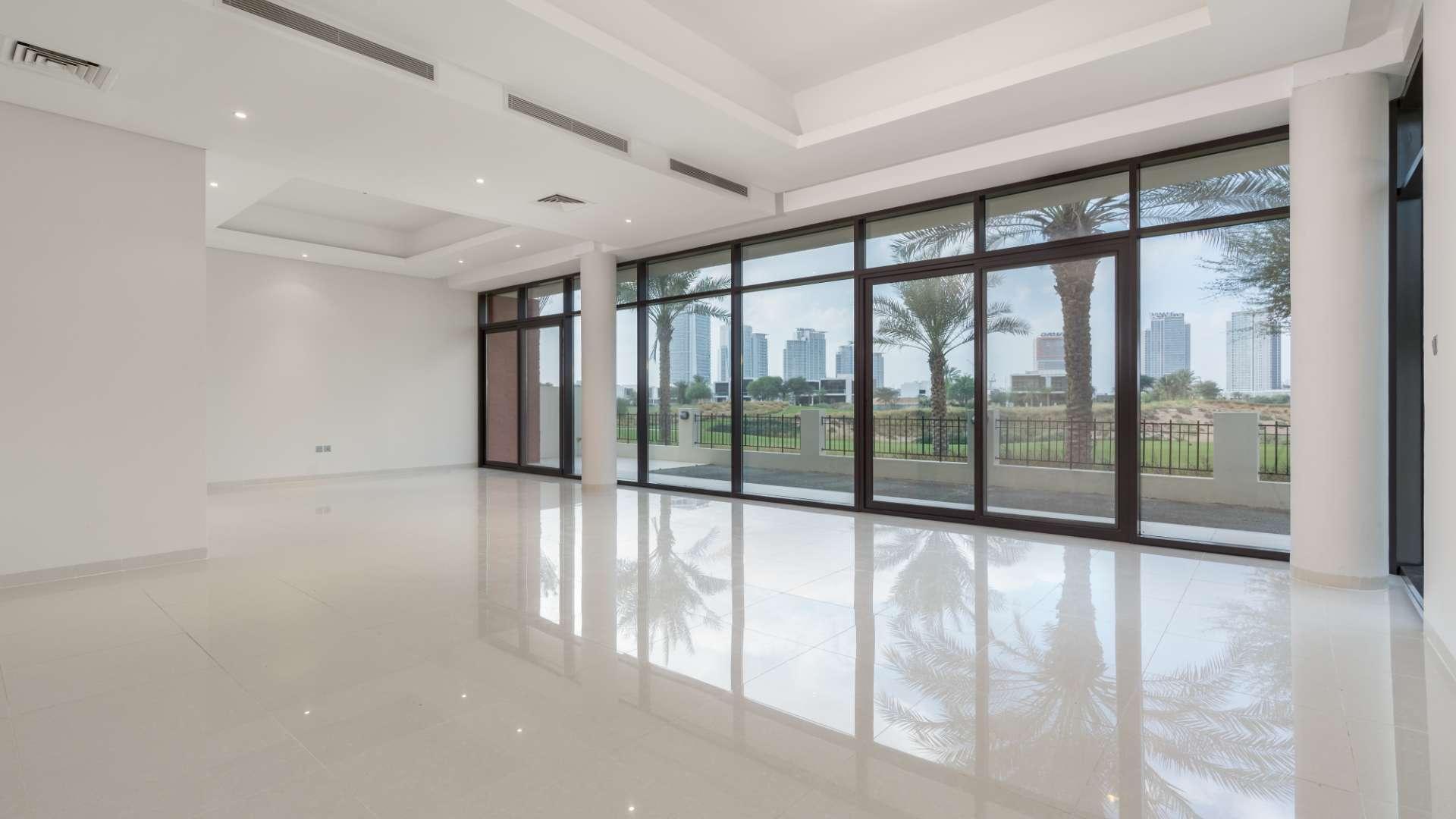 Modern 5-bedroom villa exterior in The Turf, DAMAC Hills, with lush greenery