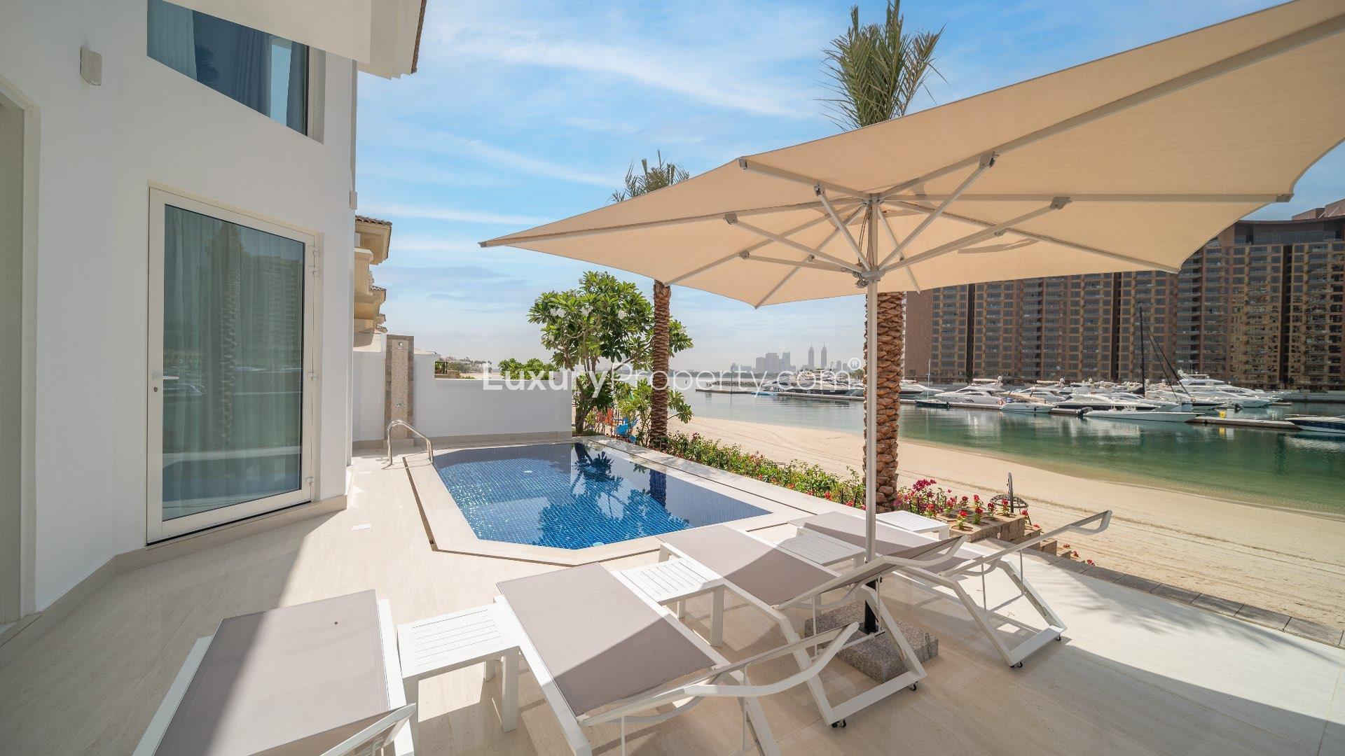 Luxurious living room in upgraded Palm Jumeirah villa with marina views, modern decor