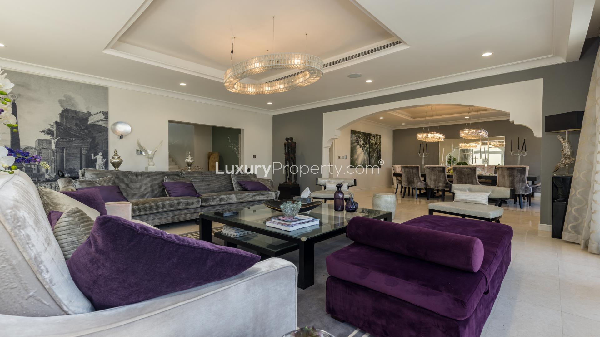 Exterior view of fully upgraded villa in Garden Homes, Palm Jumeirah, with garage and palm tree