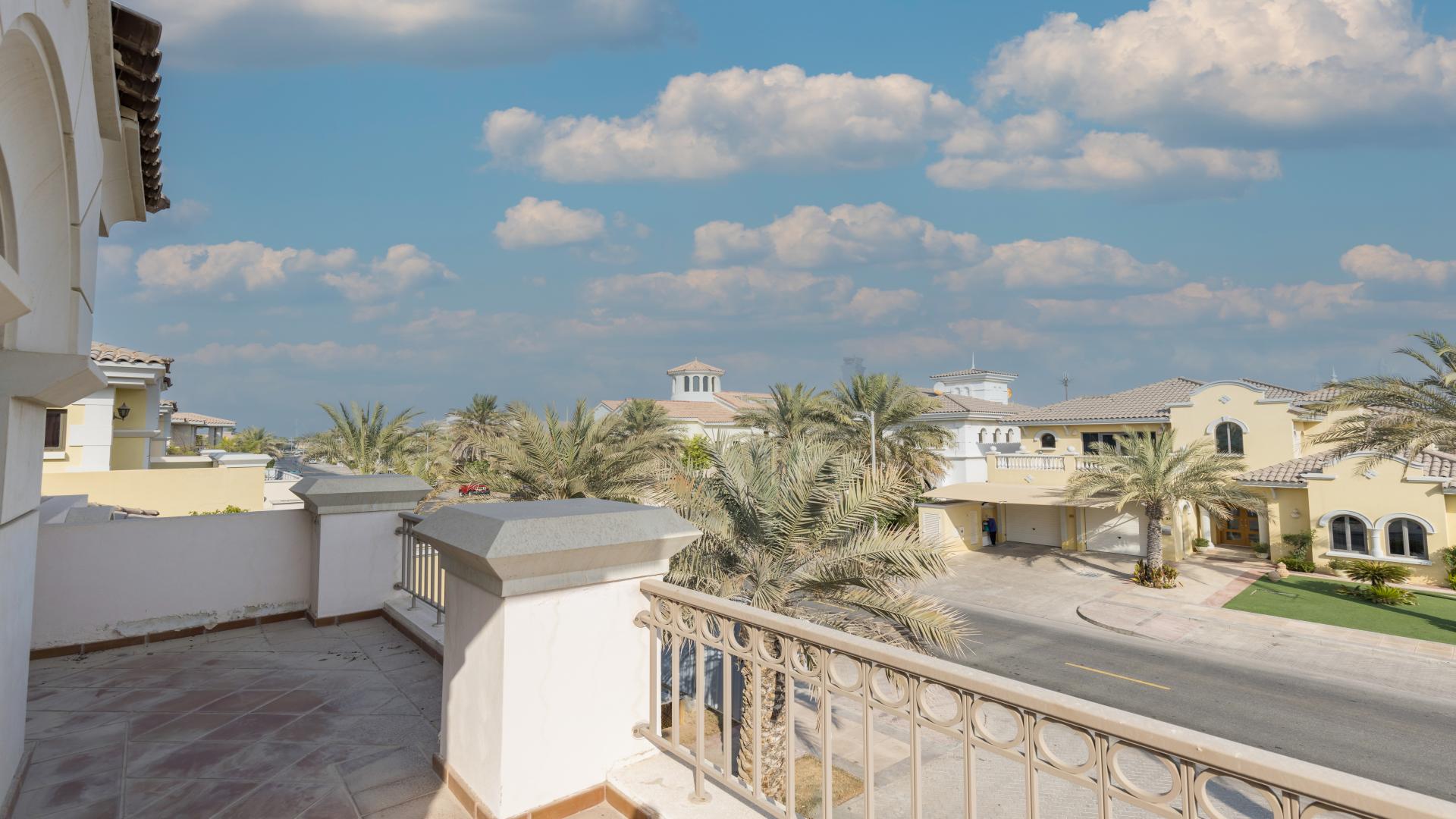 Beachfront view from Palm Jumeirah villa, showcasing serene water and luxury homes