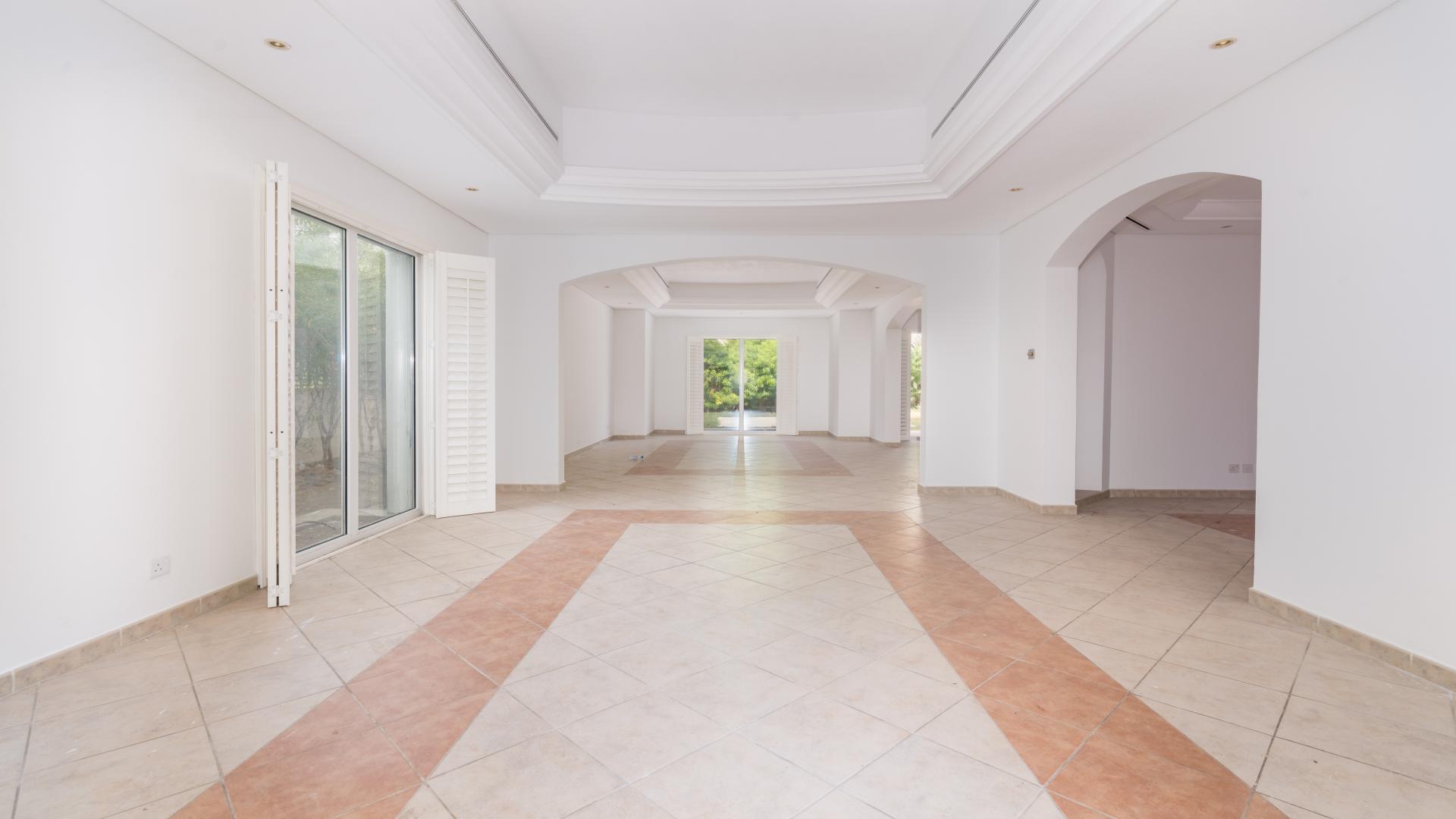 Spacious living area in park-facing villa, Green Community West, tiled floors, large windows