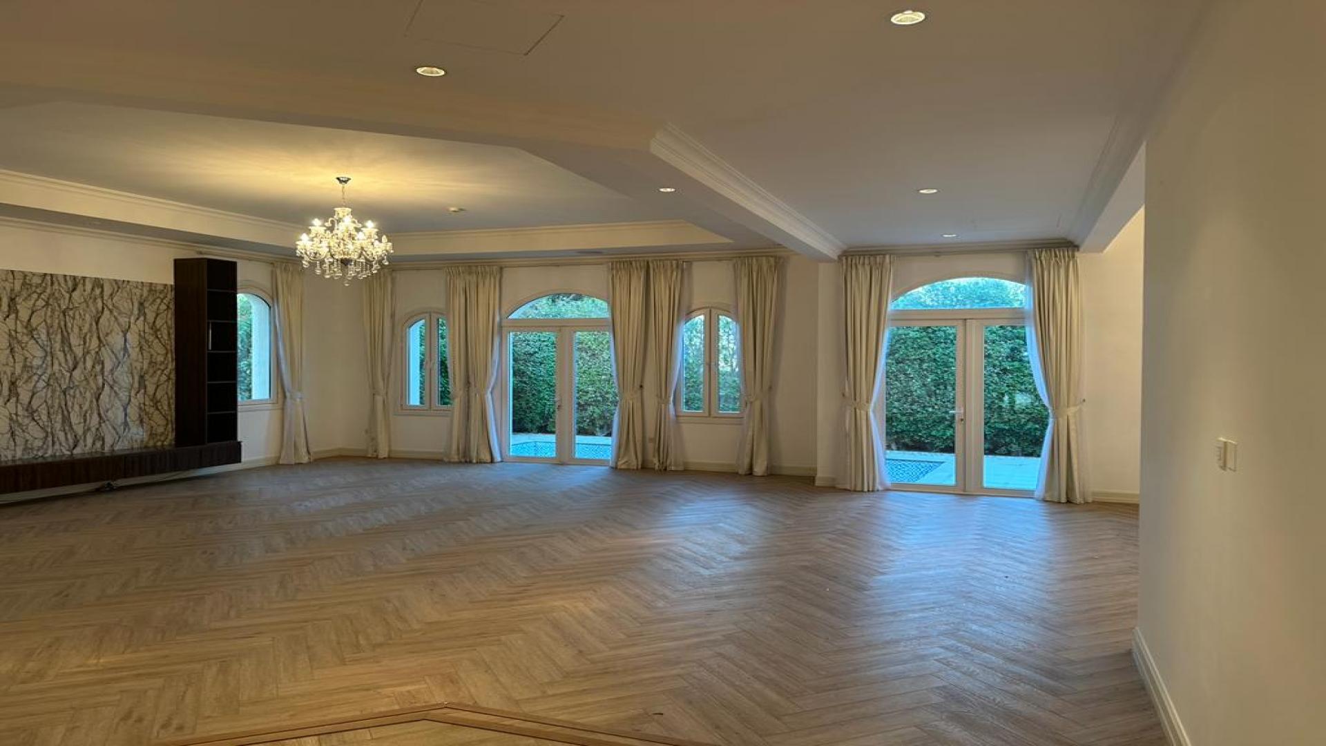 Modern kitchen in Jumeirah Golf Estates villa with marble countertops and island