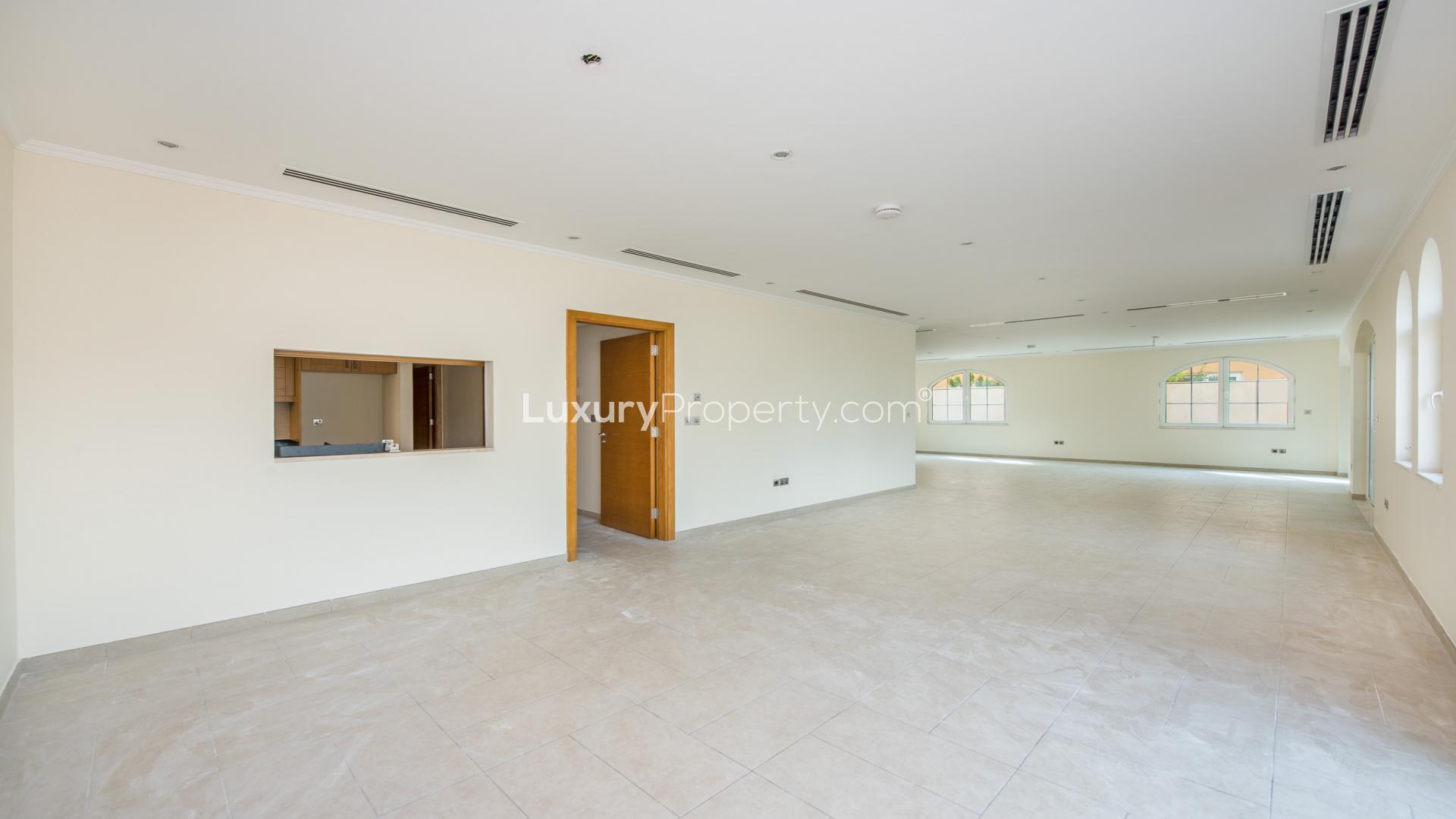 Spacious open-plan living area in Jumeirah Park villa with large windows and tiled floors