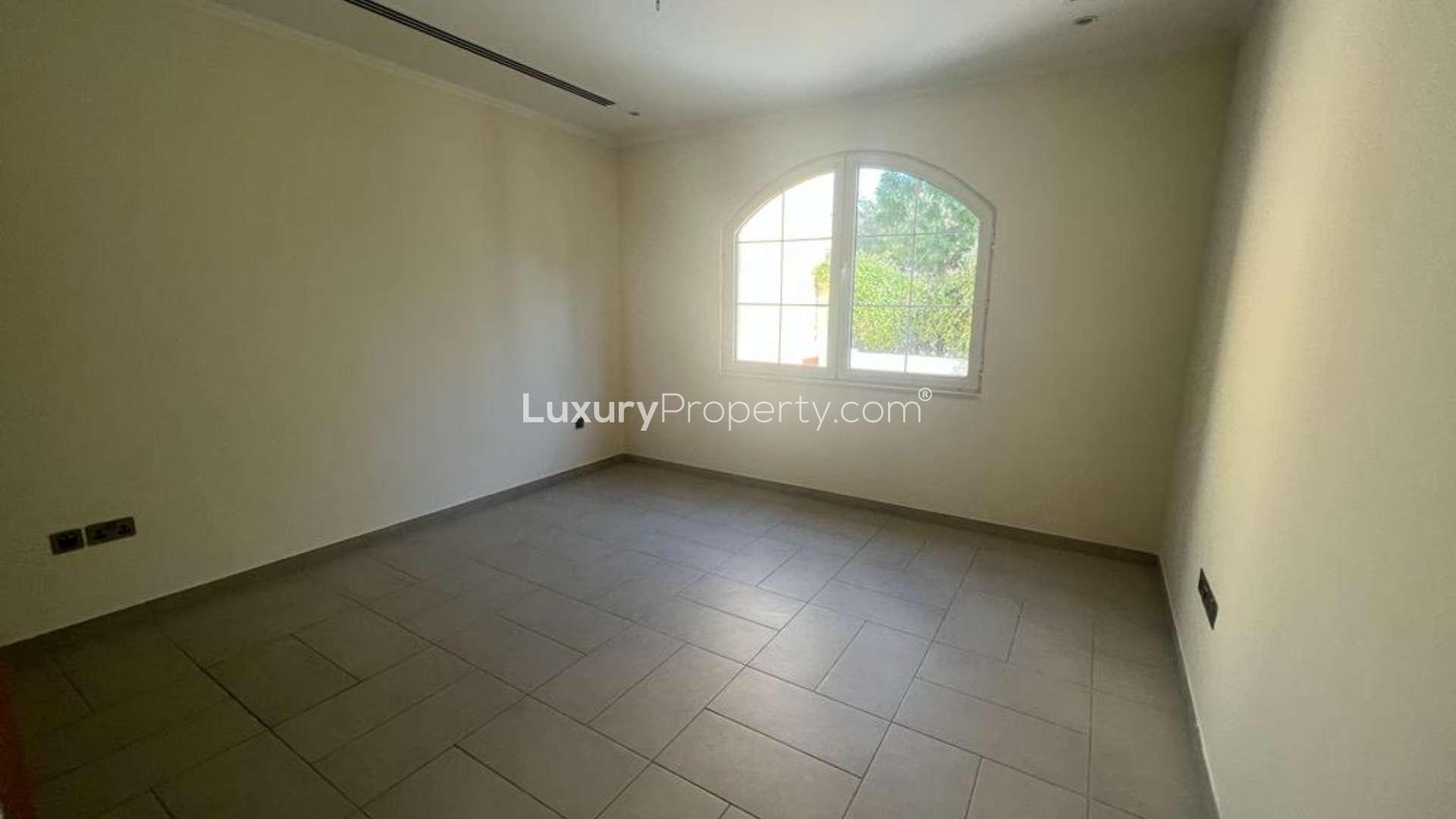 Open kitchen with wooden cabinets in Jumeirah Park Legacy Villa, available for rent