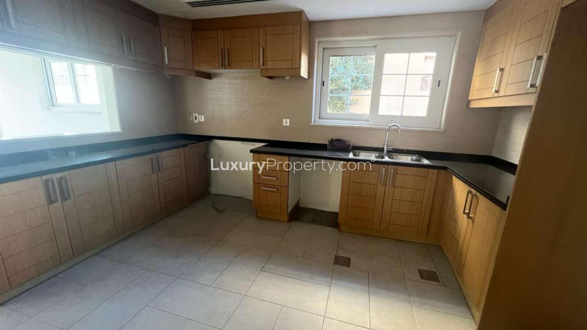 Spacious living room in 5-bedroom Legacy Villa, Jumeirah Park, with large windows and tiled floor