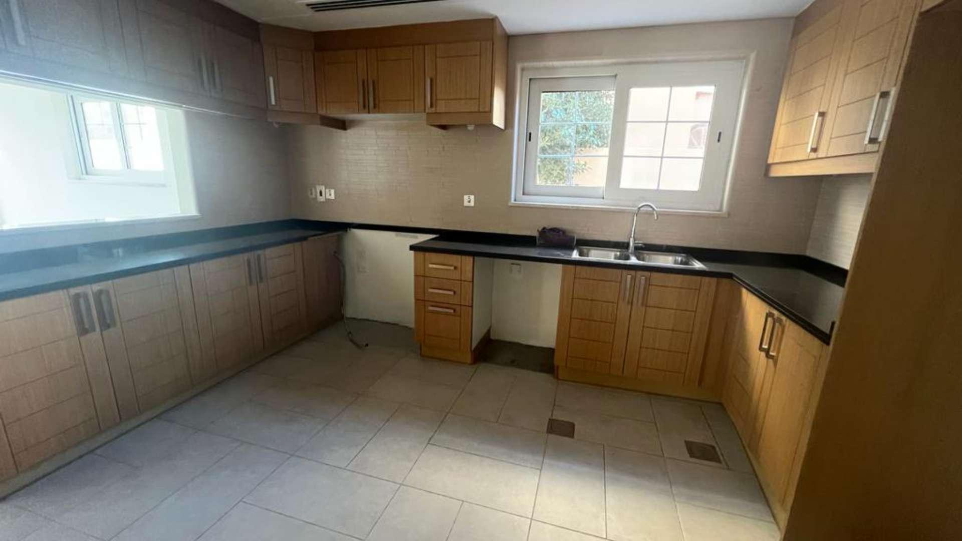 Spacious living room in 5-bedroom Legacy Villa, Jumeirah Park, with large windows and tiled floor