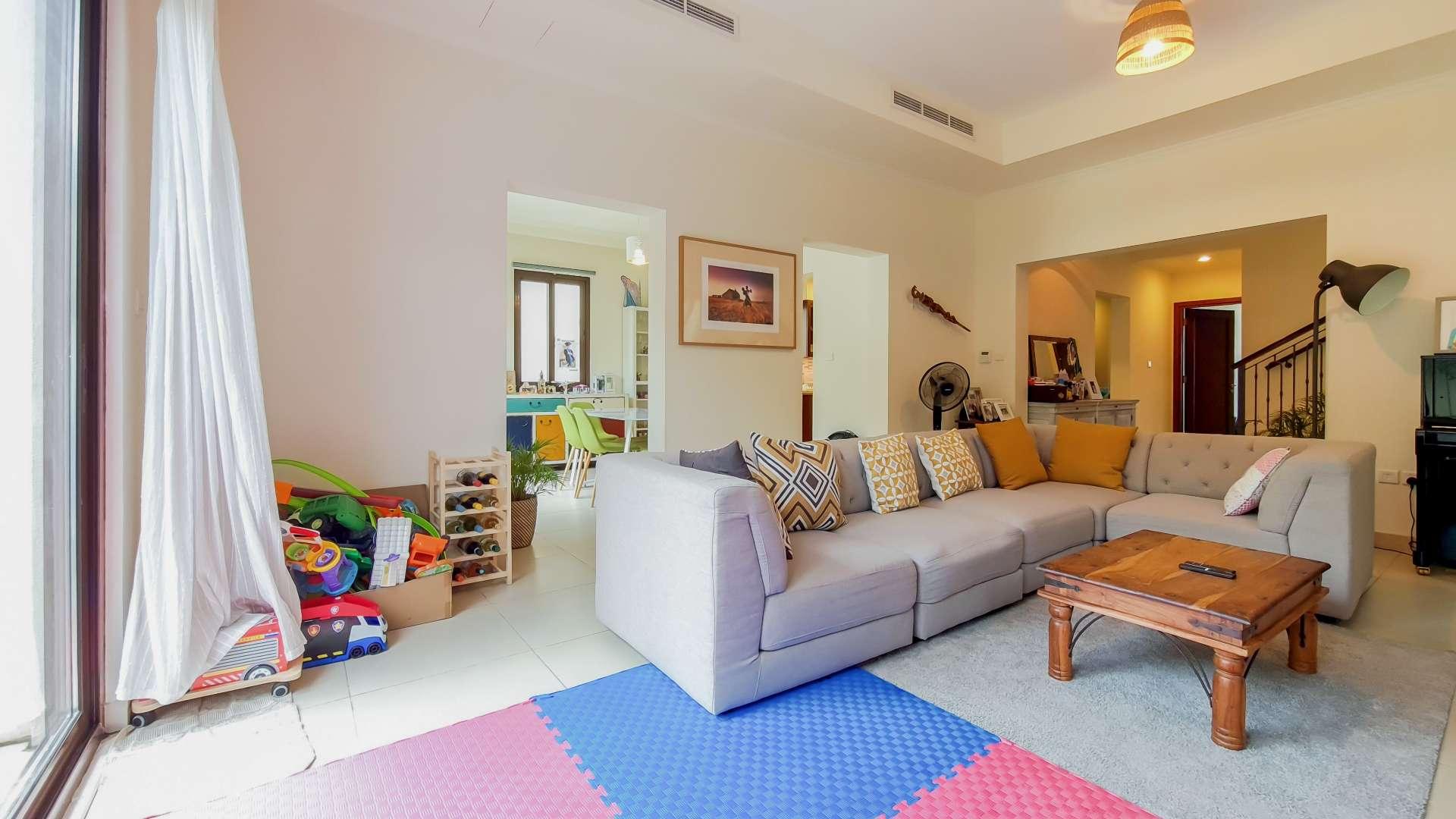 Outdoor patio of Lila villa in Arabian Ranches 2 with seating and garden