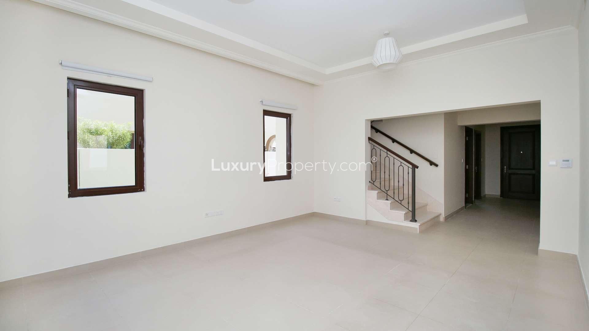 "Spacious living room with staircase in Arabian Ranches 2 villa for rent, Lila community.",N/A,Modern kitchen with wooden cabinets in Arabian Ranches 2 villa for rent, Lila community