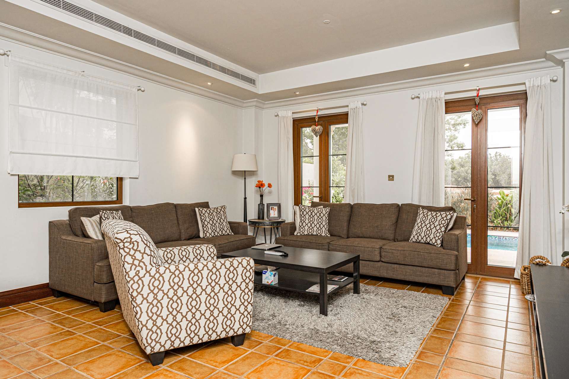 N/A,Living room in upgraded Girona-style villa, Jumeirah Golf Estates, with pool view and elegant decor