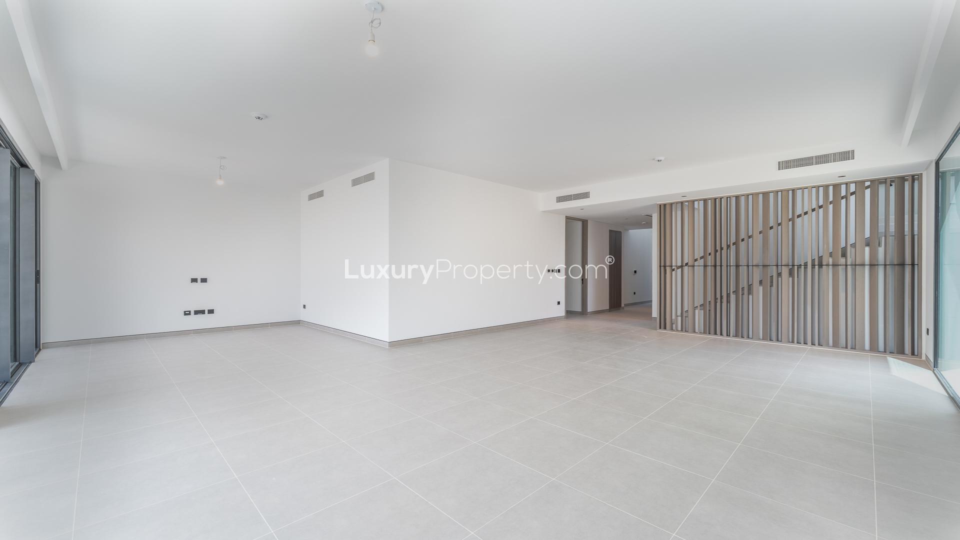 "Spacious corner villa with garden in Harmony, Tilal Al Ghaf, for rent, 5 bedrooms.",Spacious living area in premium Tilal Al Ghaf villa for rent, Harmony sub-community