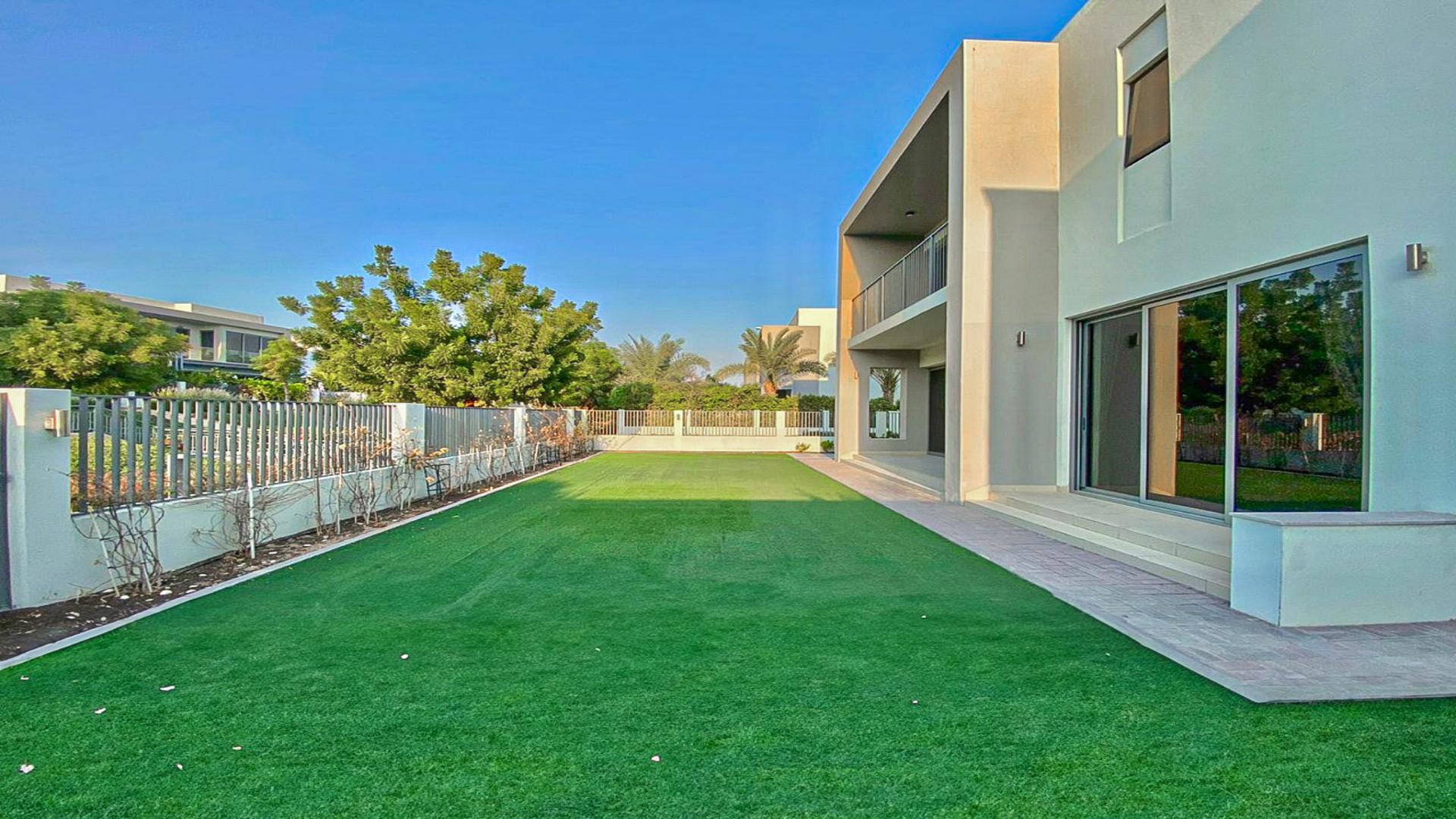Spacious living room in Sidra Villas, Dubai Hills Estate with garden view through glass doors