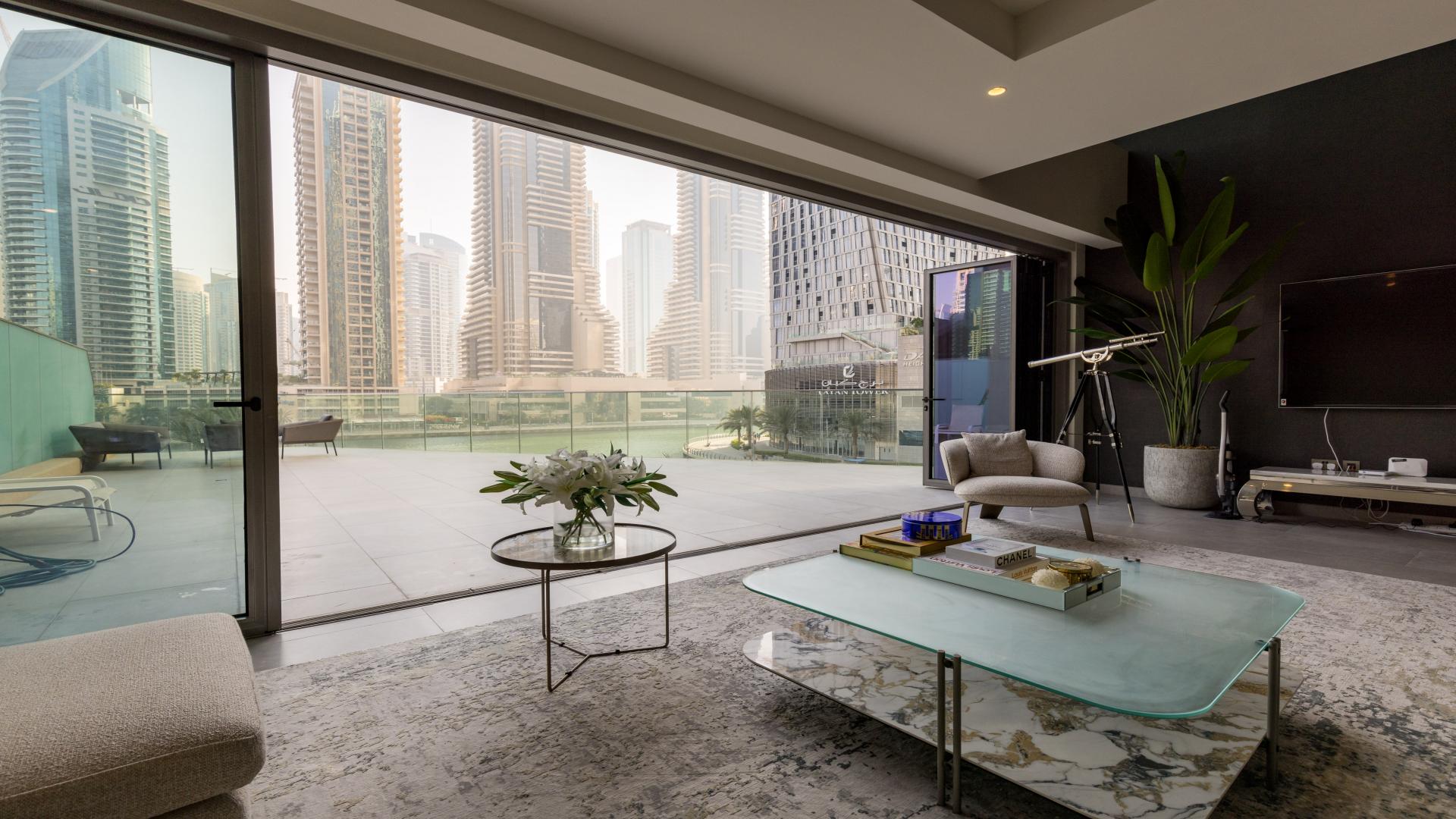 Luxurious living room in 5-bed villa, Dubai Marina, featuring modern decor and city views