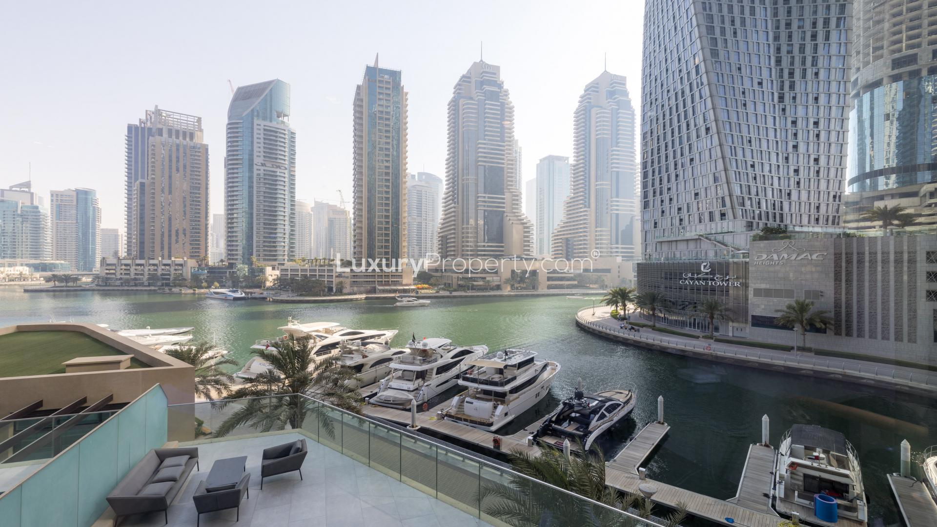Luxurious living room with Dubai Marina skyline view from Marina Gate apartment terrace
