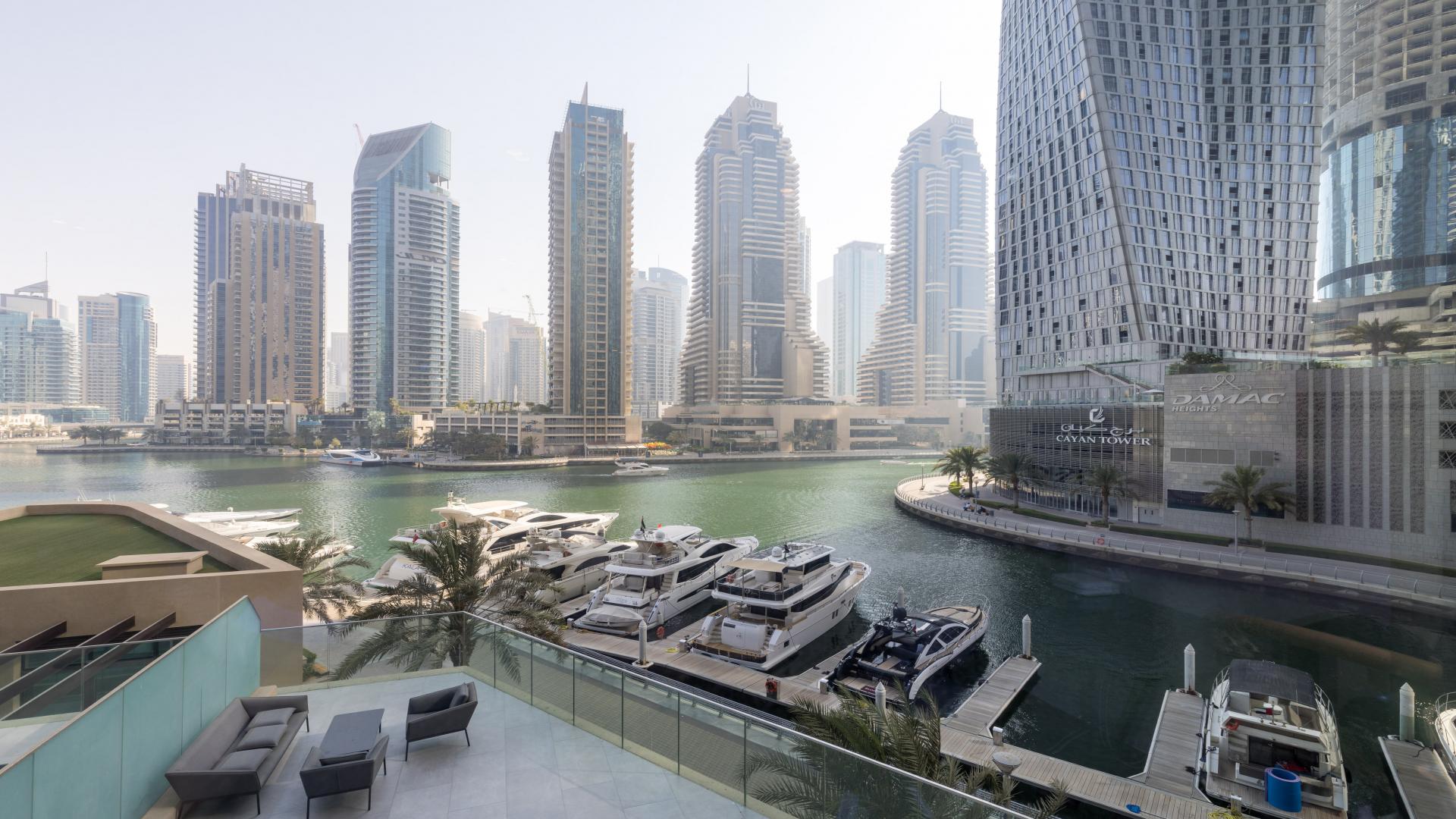 Luxurious living room with Dubai Marina skyline view from Marina Gate apartment terrace