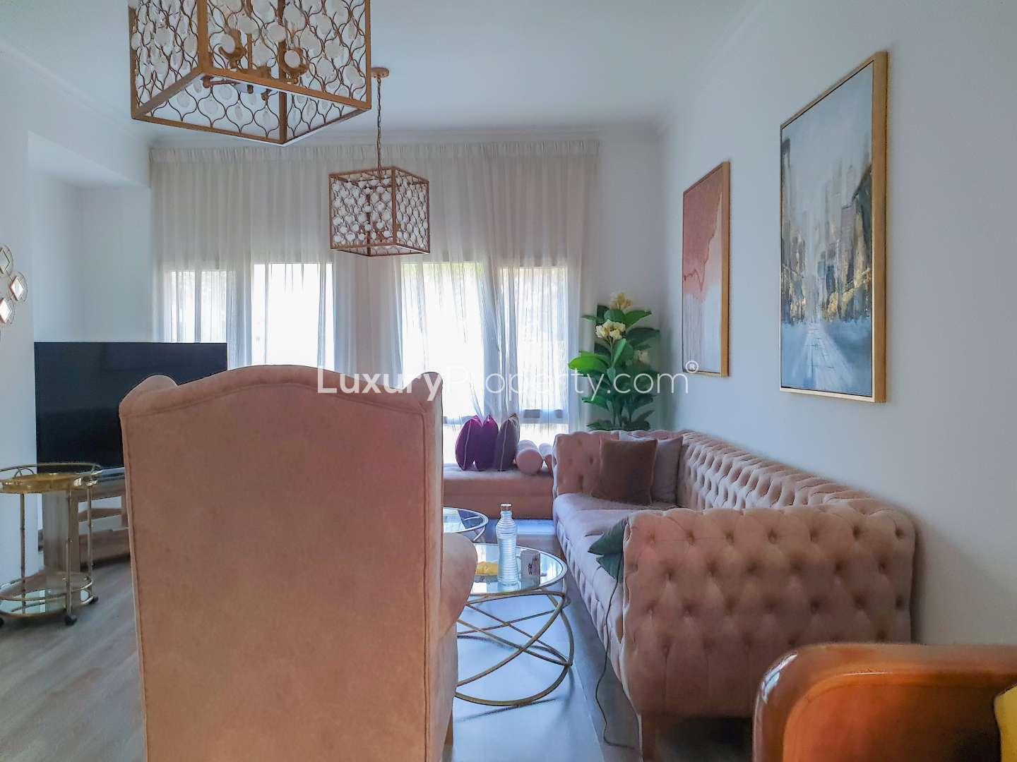 Dining area in five-bedroom villa for rent, Meadows 2, featuring elegant decor and mirror