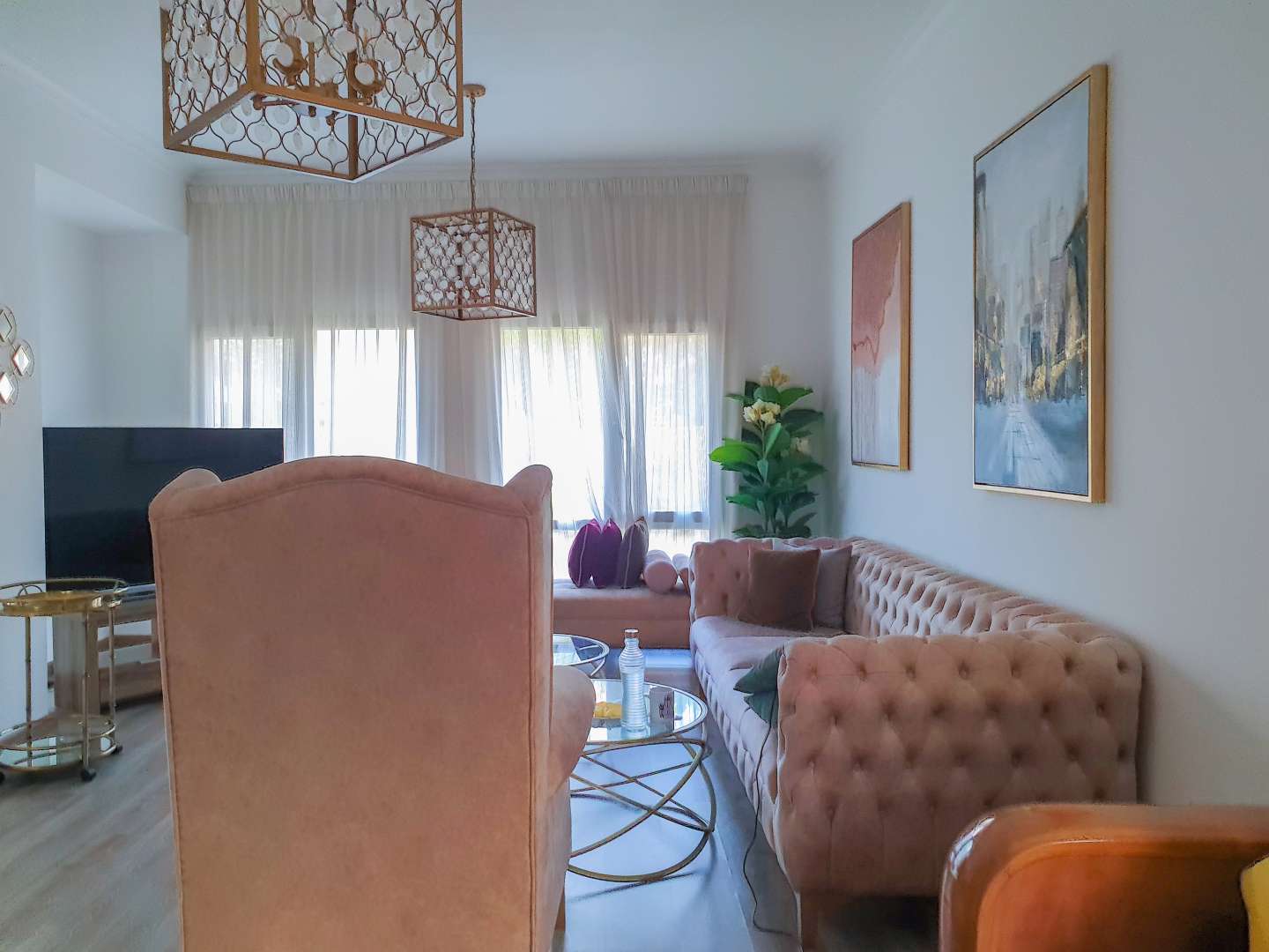 Dining area in five-bedroom villa for rent, Meadows 2, featuring elegant decor and mirror