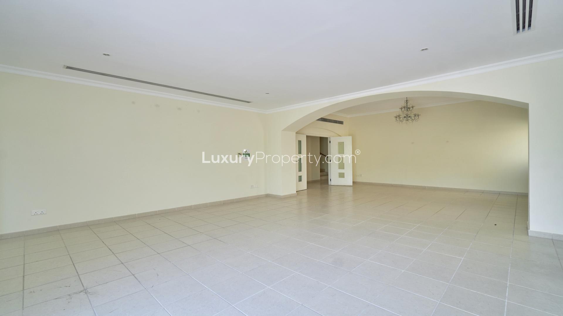 Spacious living area in 5-bedroom villa, Meadows 9, Emirates Living, with tiled floors