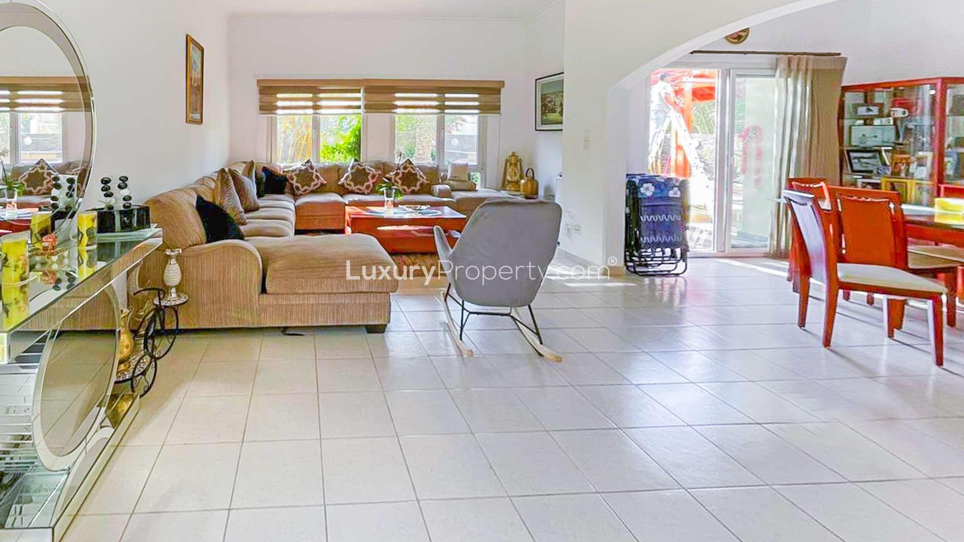 Spacious living room in Meadows 8 villa with modern decor and large windows