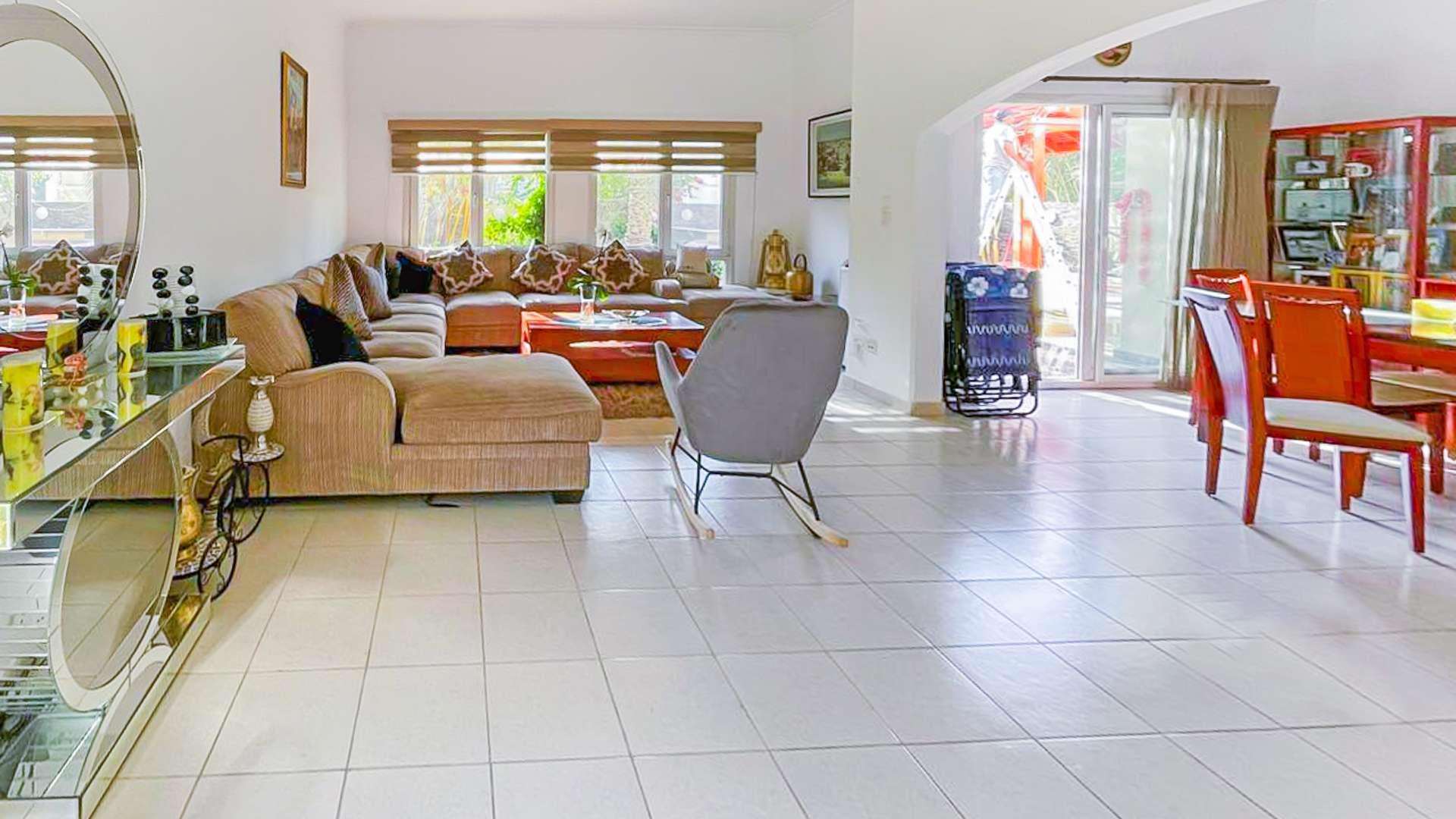 Spacious living room in Meadows 8 villa with modern decor and large windows