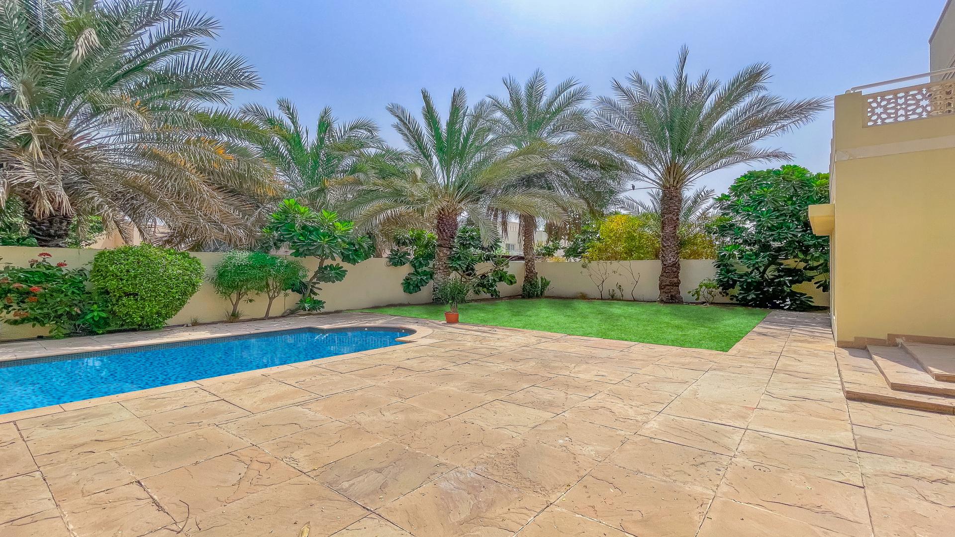 Spacious kitchen and living area in Meadows 2 villa with large windows and garden view