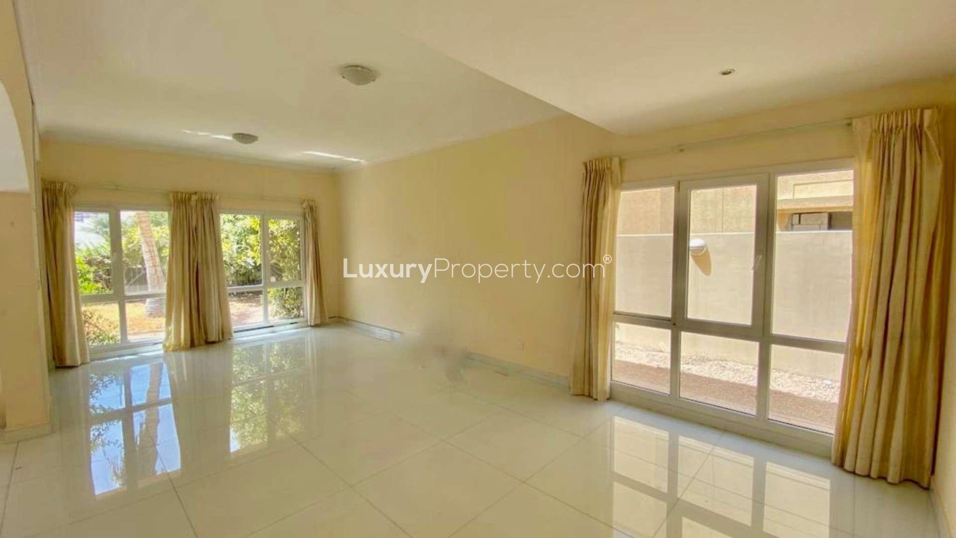 "Spacious villa balcony overlooking lake and skyline in Meadows 2, Dubai, for rent.",Bright living room with large windows in Meadows 2 Type 7 Villa for rent