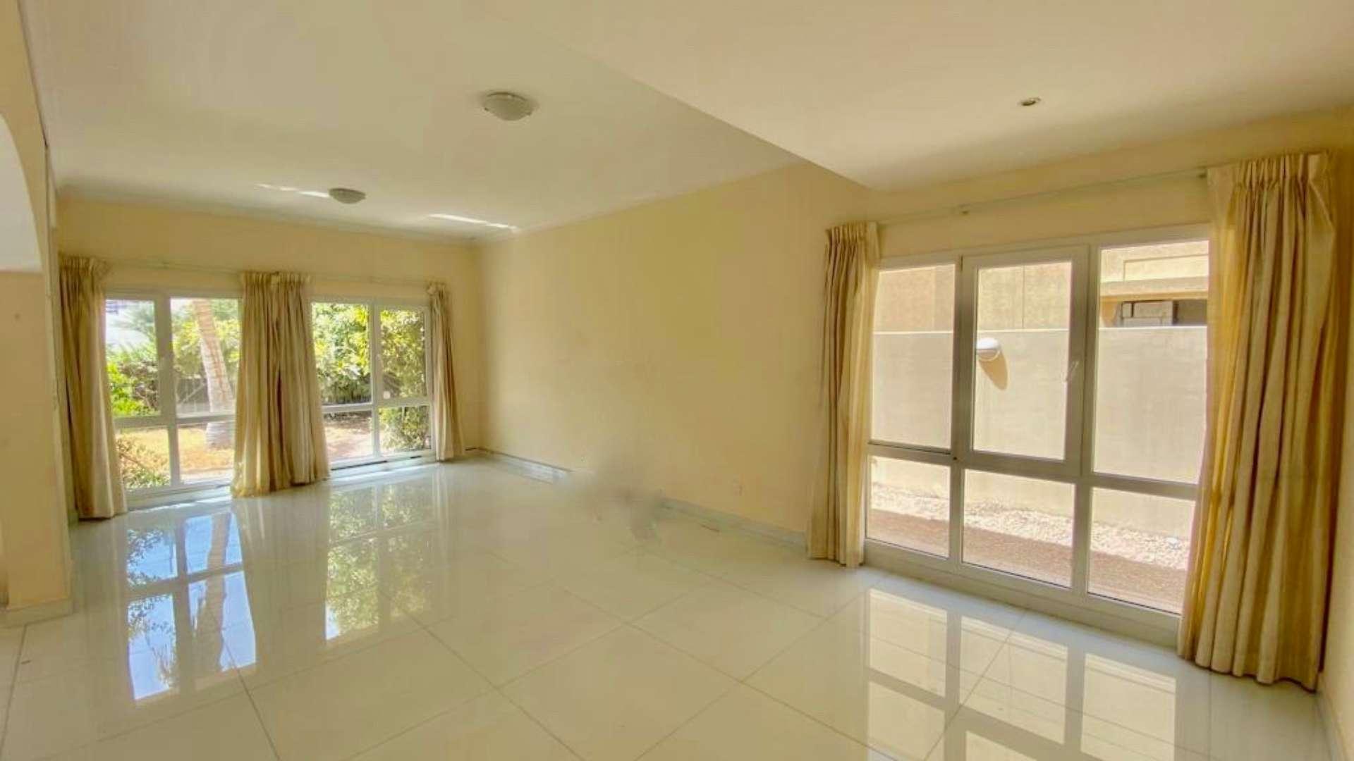 "Spacious villa balcony overlooking lake and skyline in Meadows 2, Dubai, for rent.",Bright living room with large windows in Meadows 2 Type 7 Villa for rent