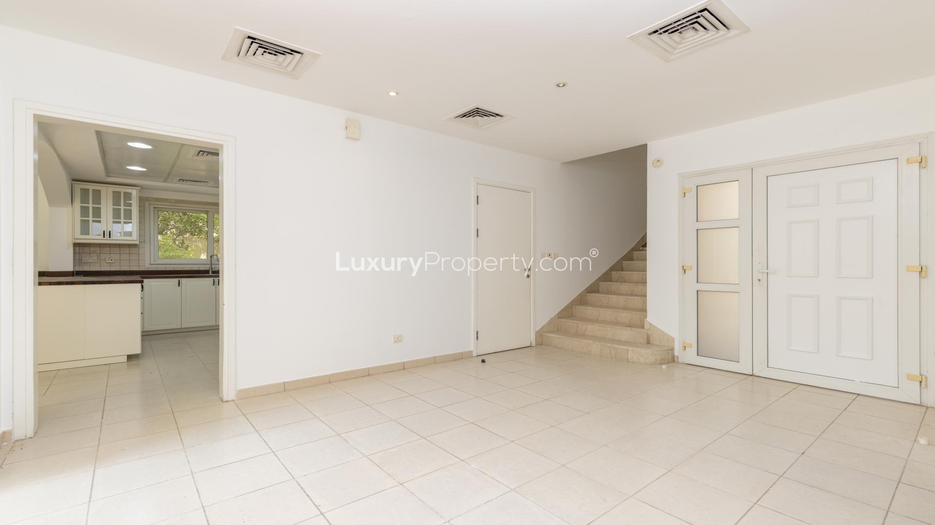 Front view of upgraded Vastu villa in Meadows 9, featuring lush garden entrance