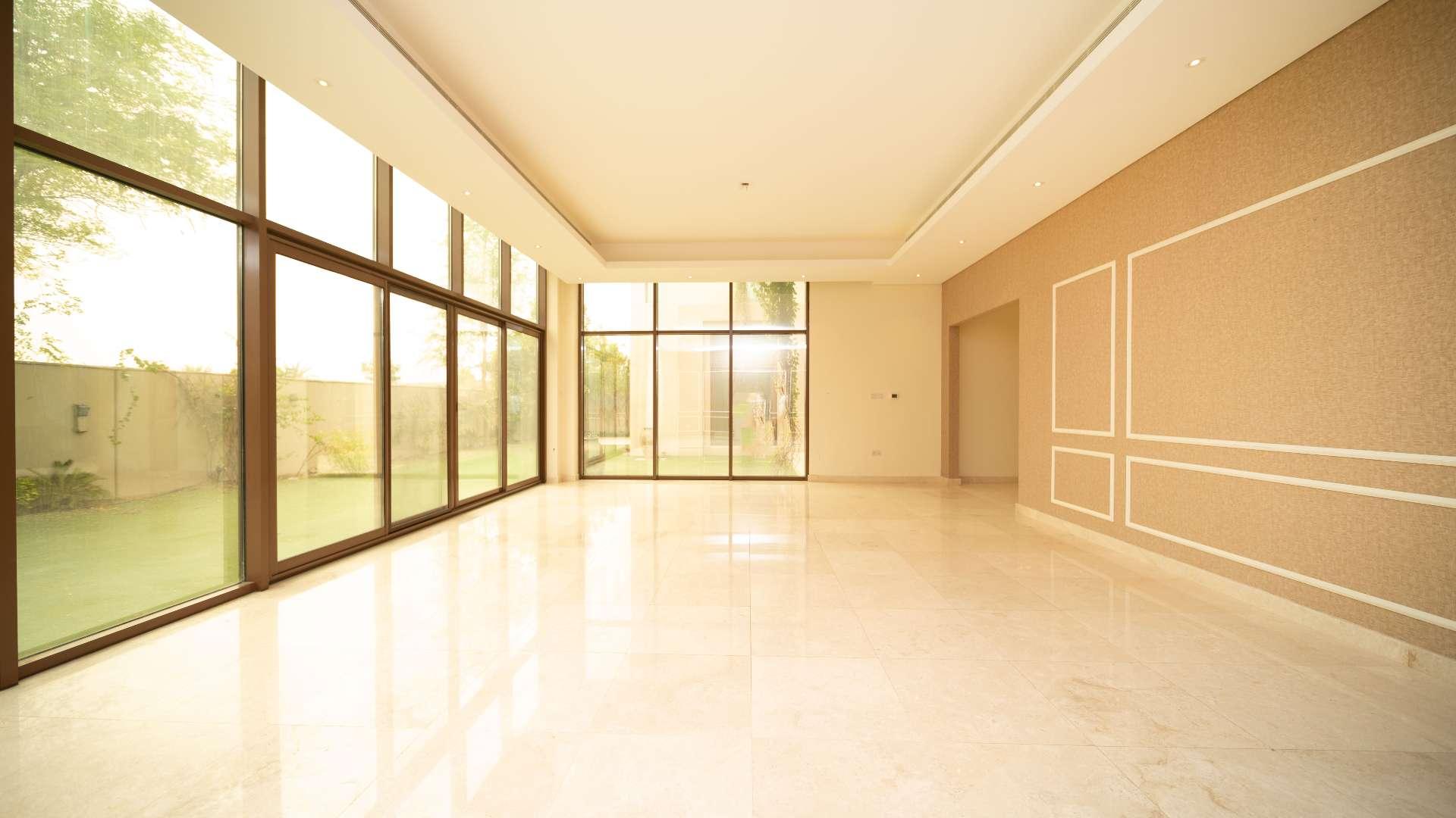 Spacious living room with large windows in Meydan Millennium Estates villa for rent